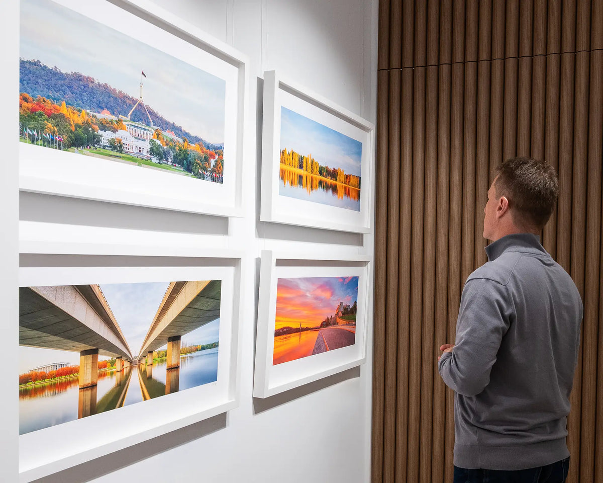 Sy Light. Sunrise over Lake Burley Griffin, admired in gallery with more Canberra artworks.