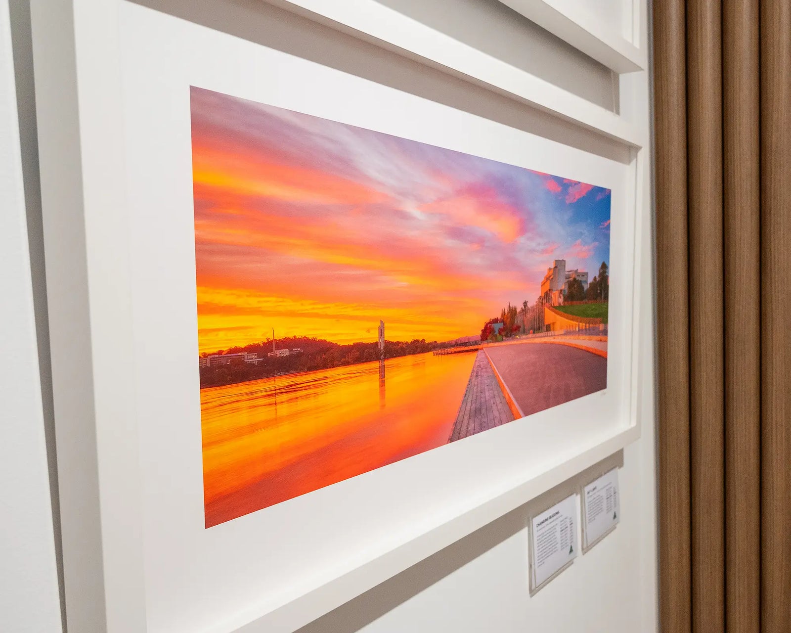 Framed photograph of a sunset over Lake Burley Griffin with the Carillon and High Court in the background.