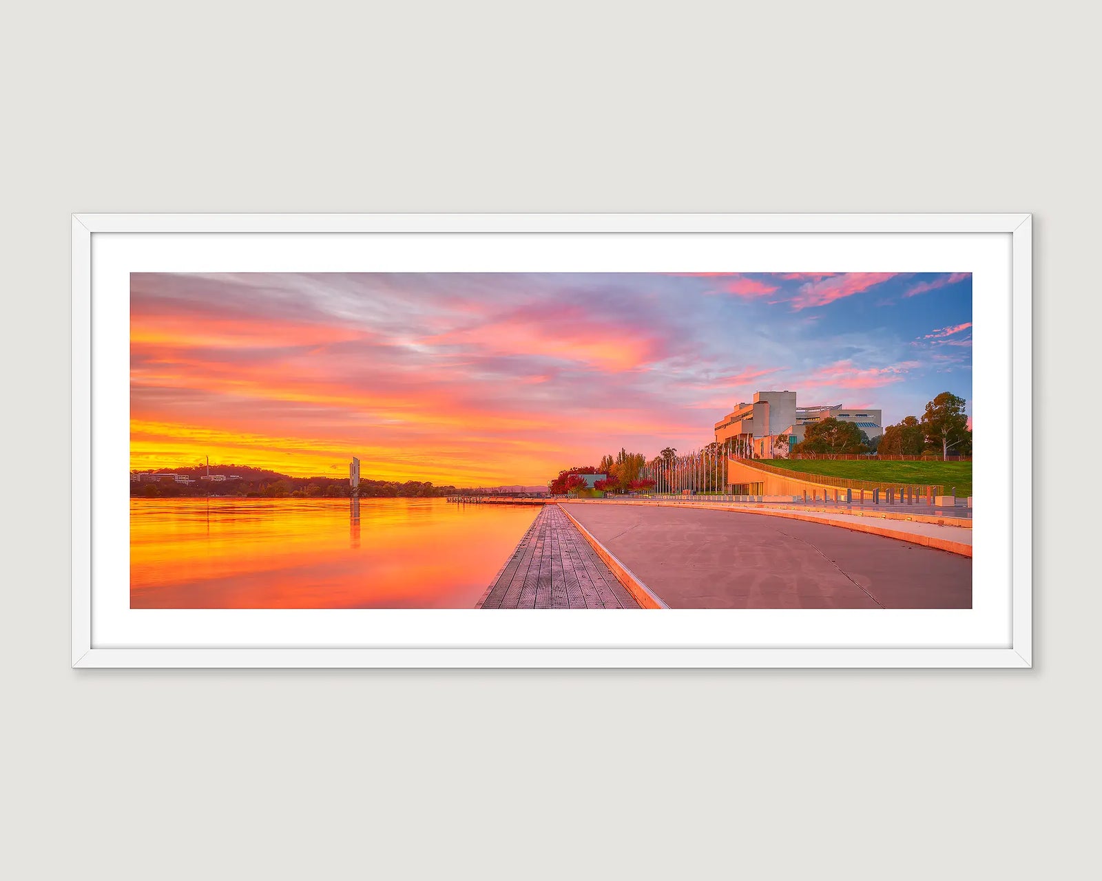 Framed photograph of a sunset over Lake Burley Griffin with the Carillon and High Court in the background.