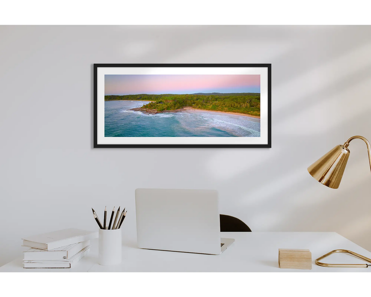 South Coast Escape. Wall art print of a sunrise over Durras, with a black frame in a work from home office. 