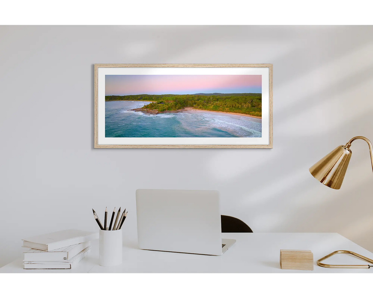 South Coast Escape. Wall art print of a sunrise over Durras, with a timber frame in a work from home office. 