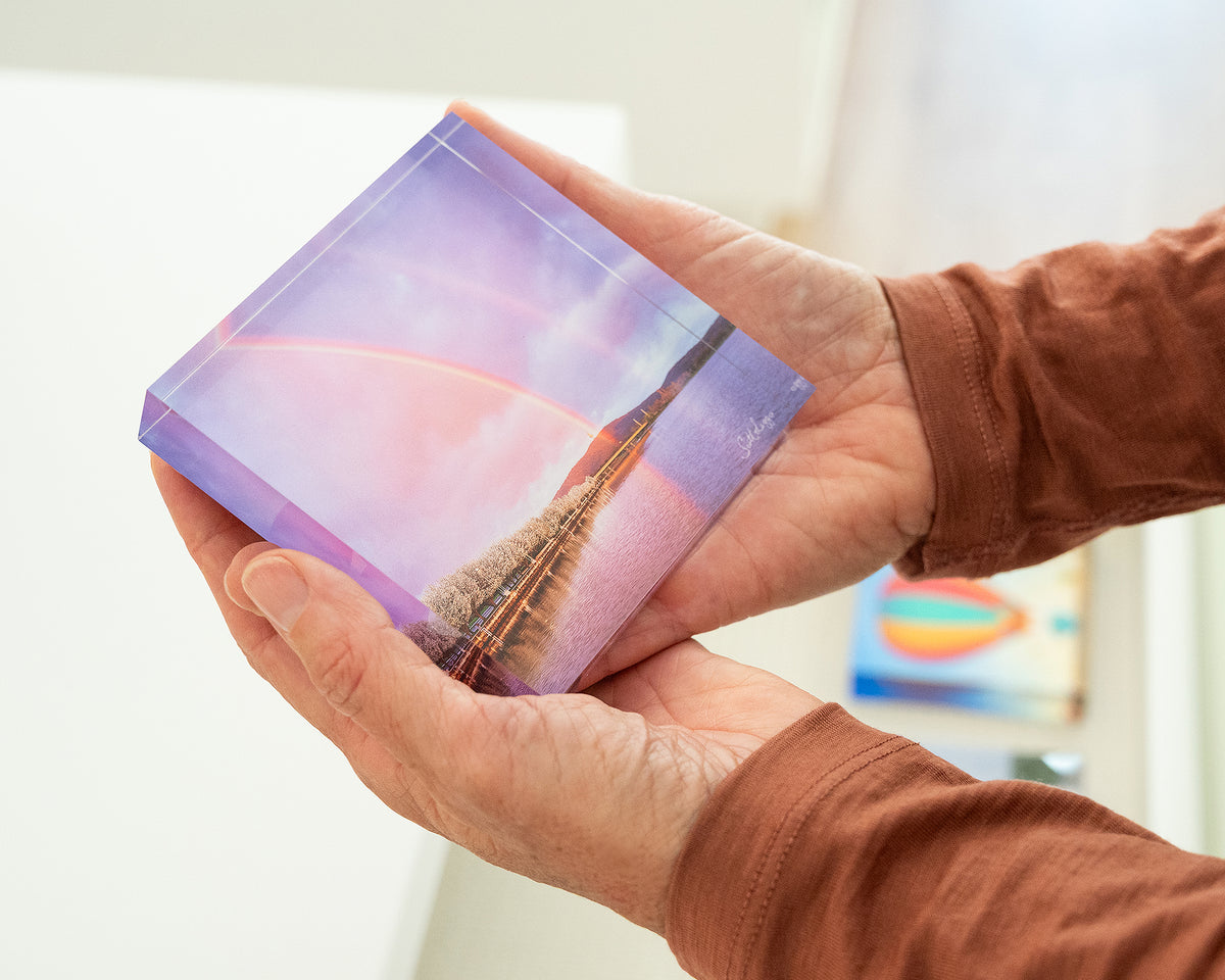 Spring Delight.  Acrylic block of a double rainbow over Lake Burley Griffin, held in hands.