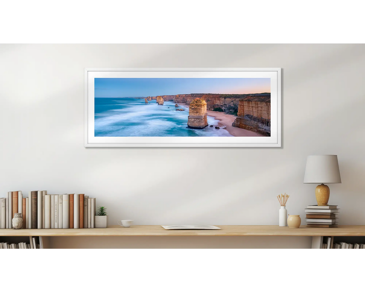 Standing Strong Twelve Apostles panoramic wall art print with white frame in home office.