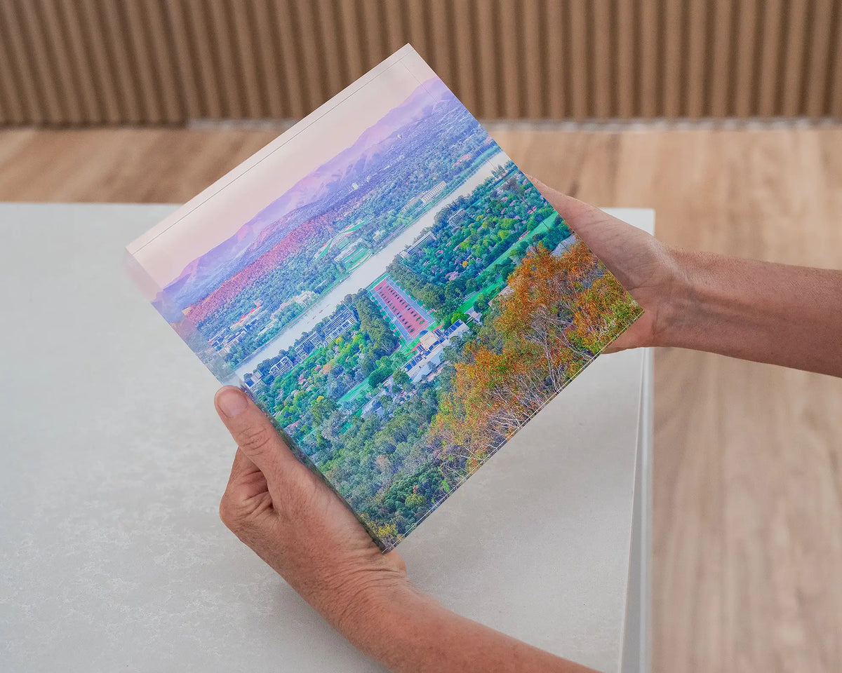 State Of Flux. Acrylic block of a Canberra sunrise from Mount Ainslie, held in hands.