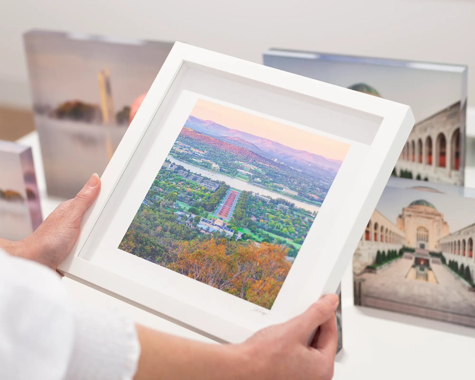 Framed landscape photograph of Canberra cityscape with mountains in the background.