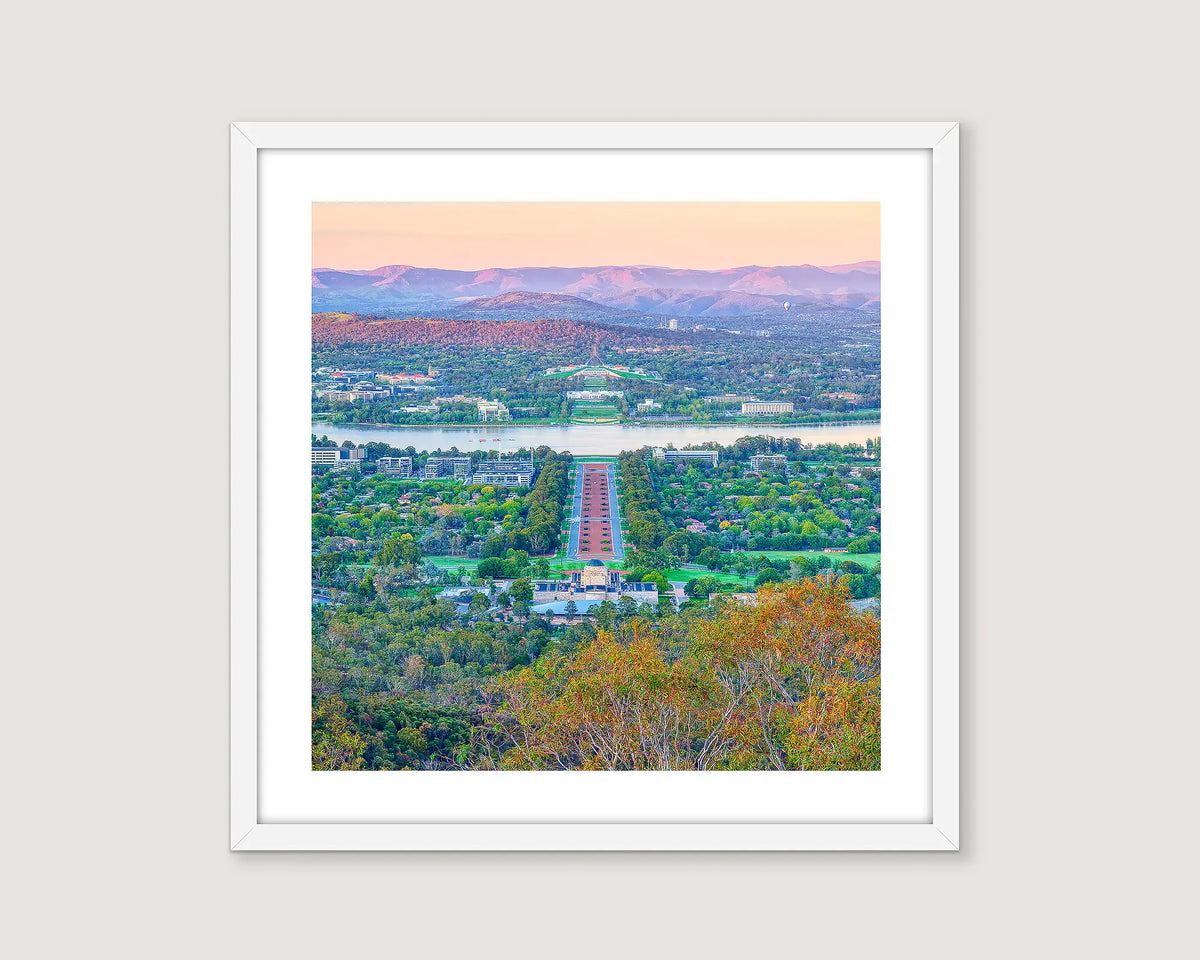 Framed landscape photograph of Canberra cityscape with mountains in the background.