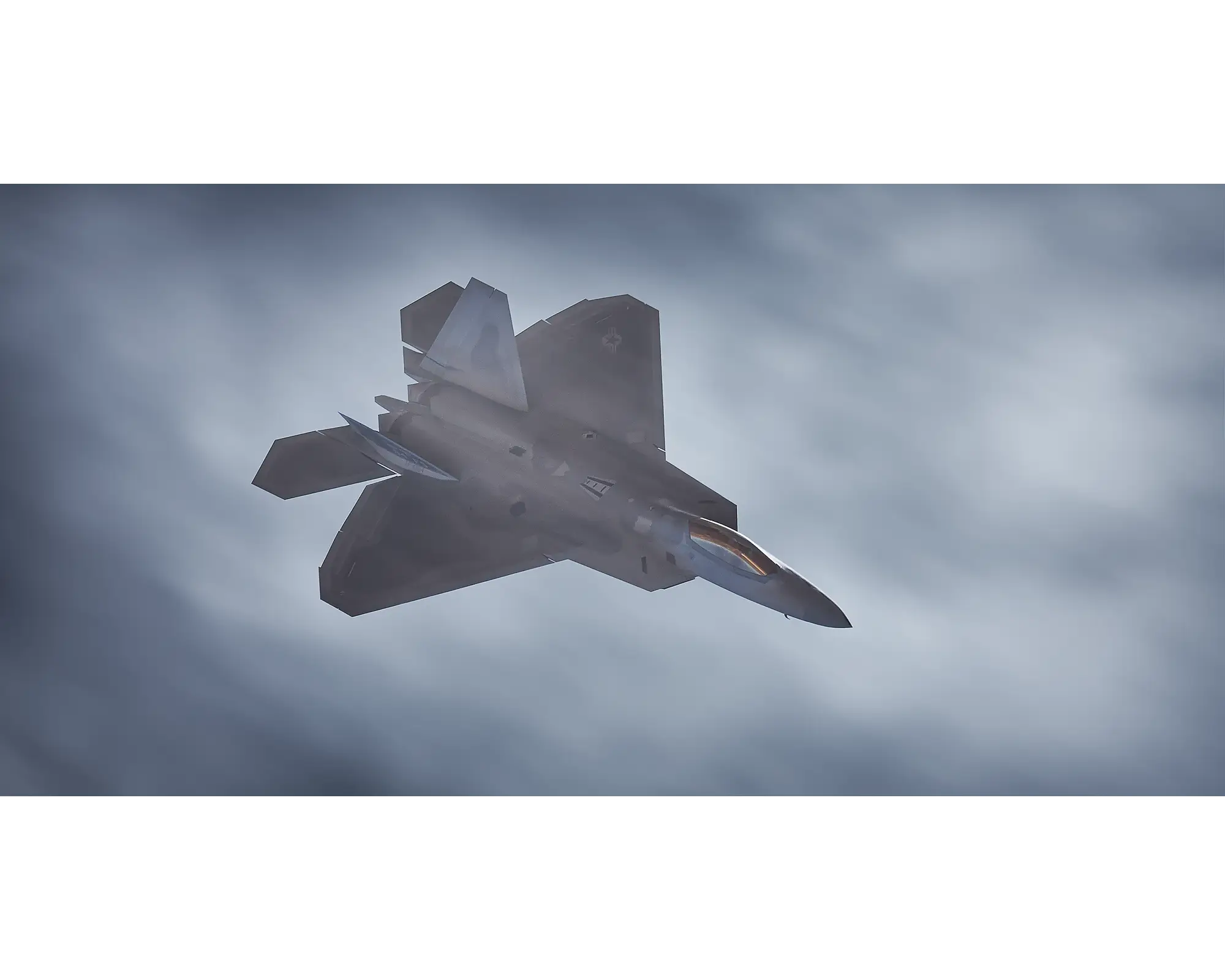 Stealth Fighter. United STates Air Force F-22 Raptor flying next to clouds.