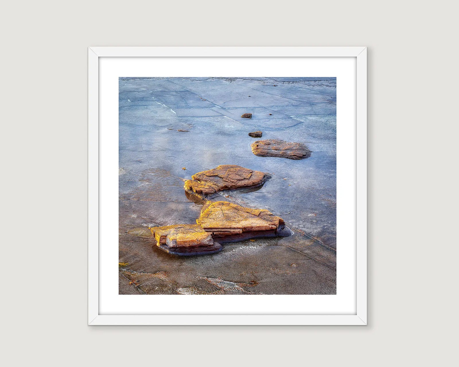 Framed abstract photograph of rocks in water.