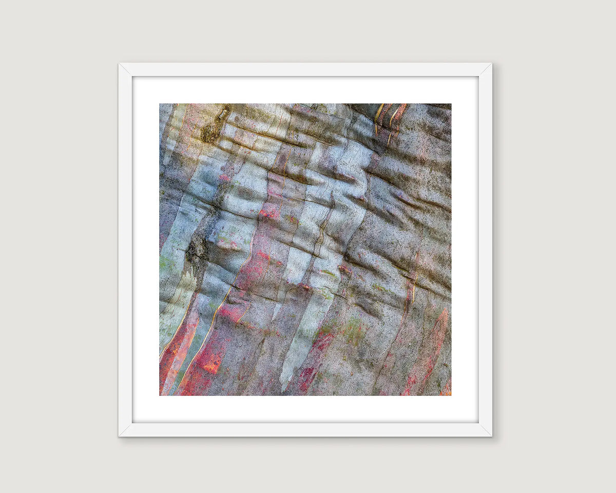Framed abstract art print with muted earth tones on a light grey wall.