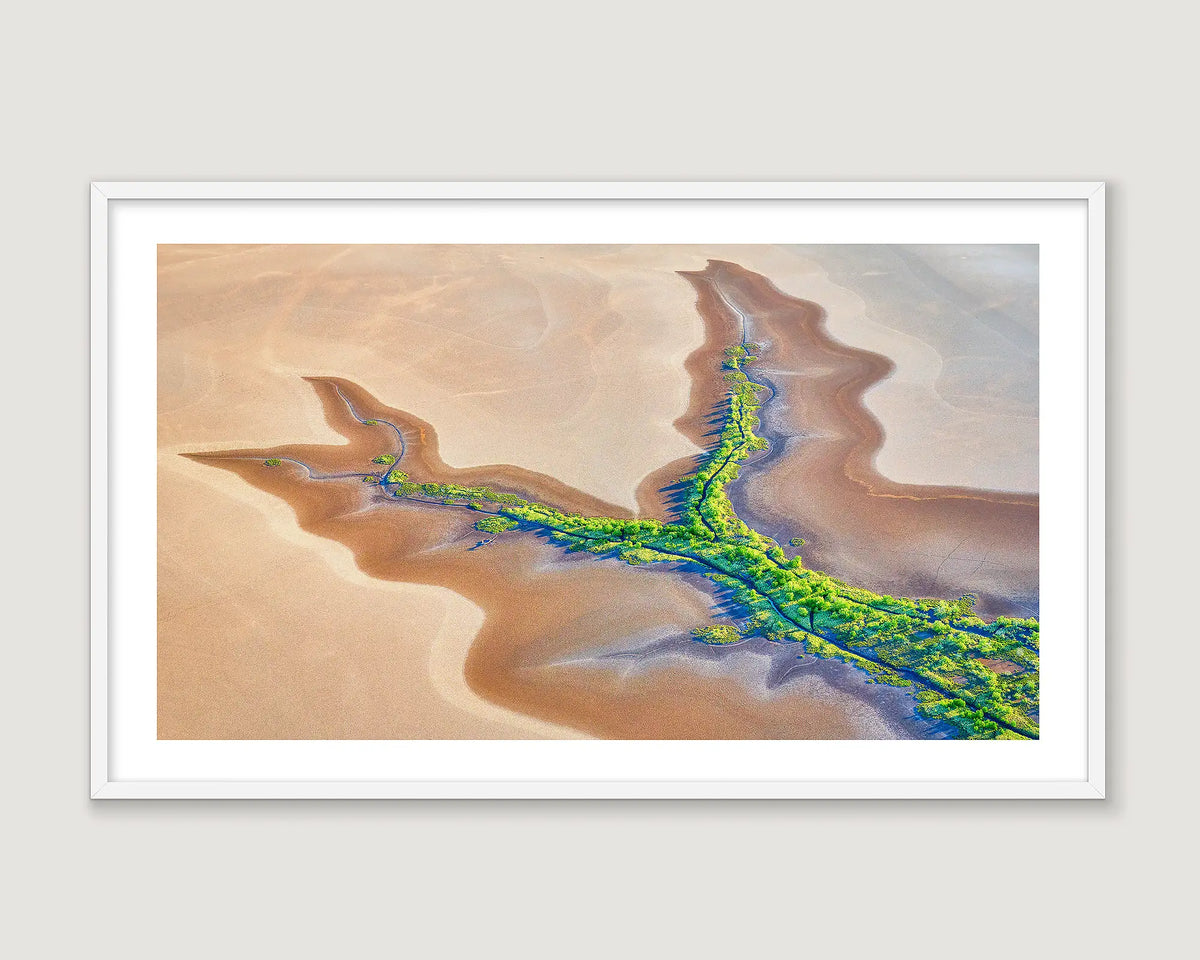 Framed abstract artwork of a desert landscape with winding tidal patterns and greenery.