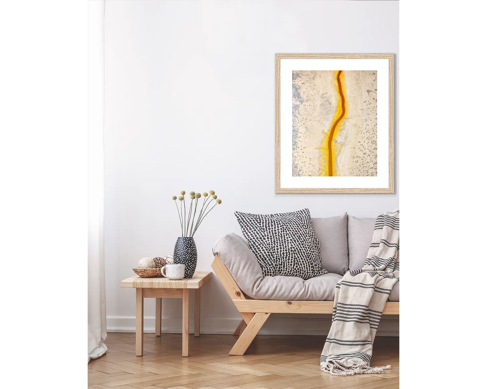 Framed abstract art with a yellow, beige and grey colour scheme on a white background.