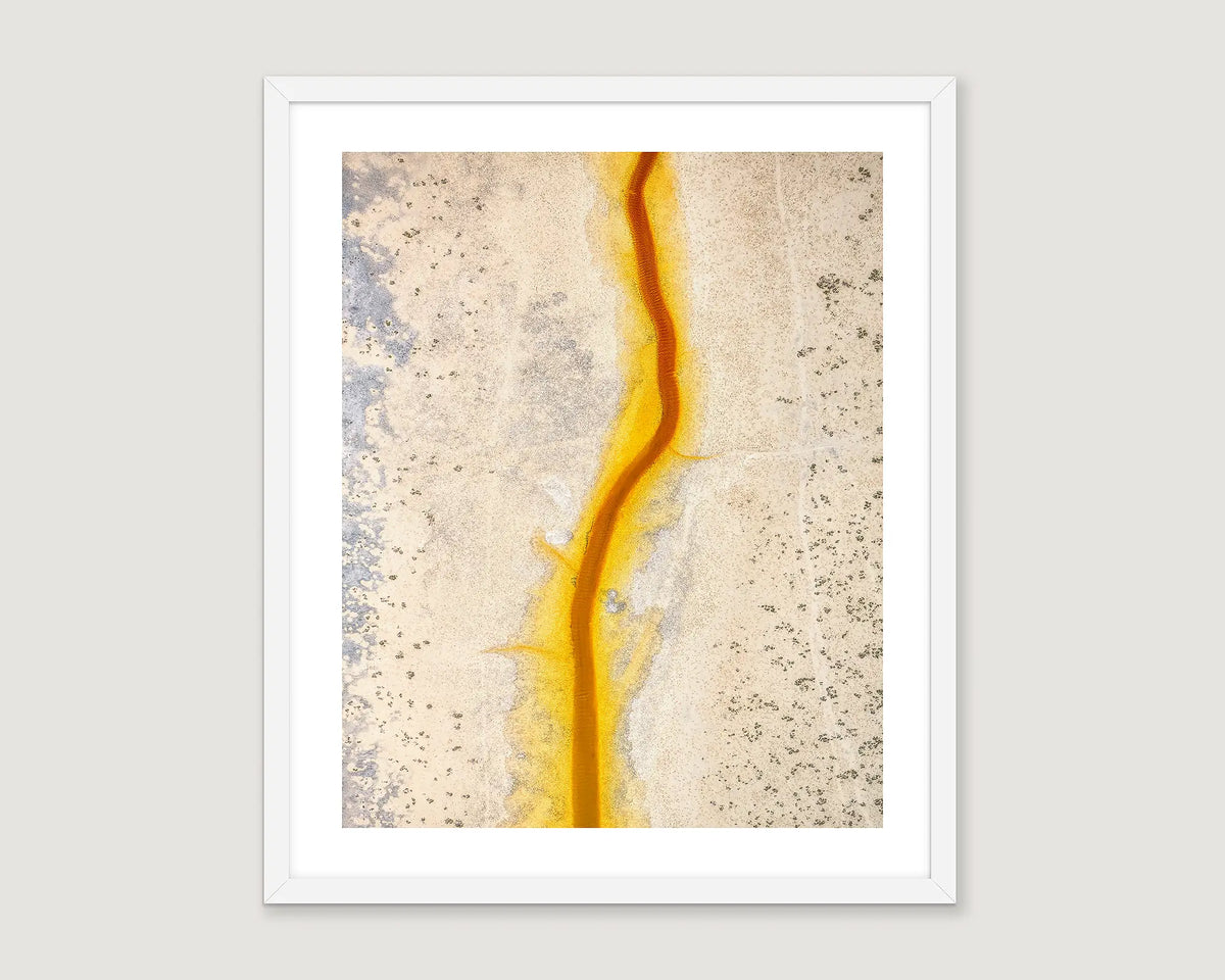Framed abstract art with a yellow, beige and grey colour scheme on a white background.