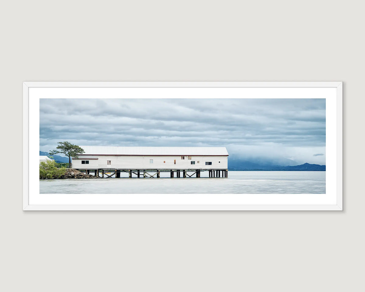 Framed landscape photograph of Sugar Wharf on the ocean and a stormy sky.