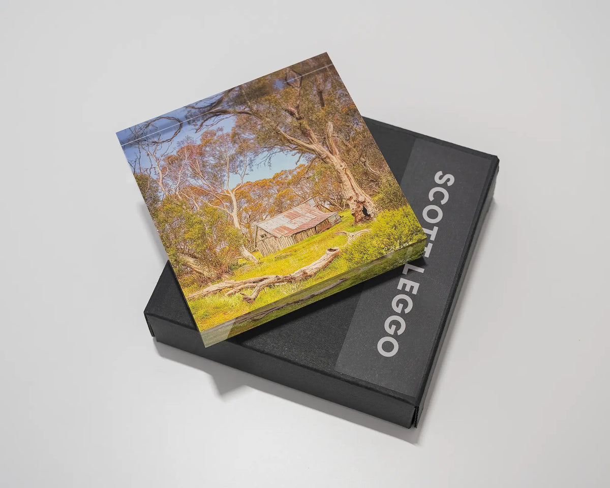 Summer in the High Country. Acrylic block of Wallace Hut, Victoria laying flat on a gift box. 