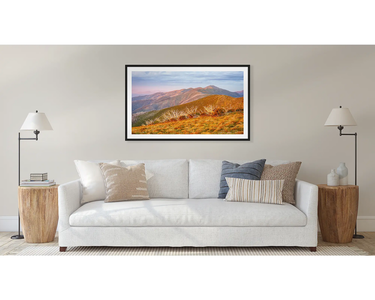 Summer Light framed landscape art print with a black frame, hung on a beige wall above a white sofa in a modern living room setting.
