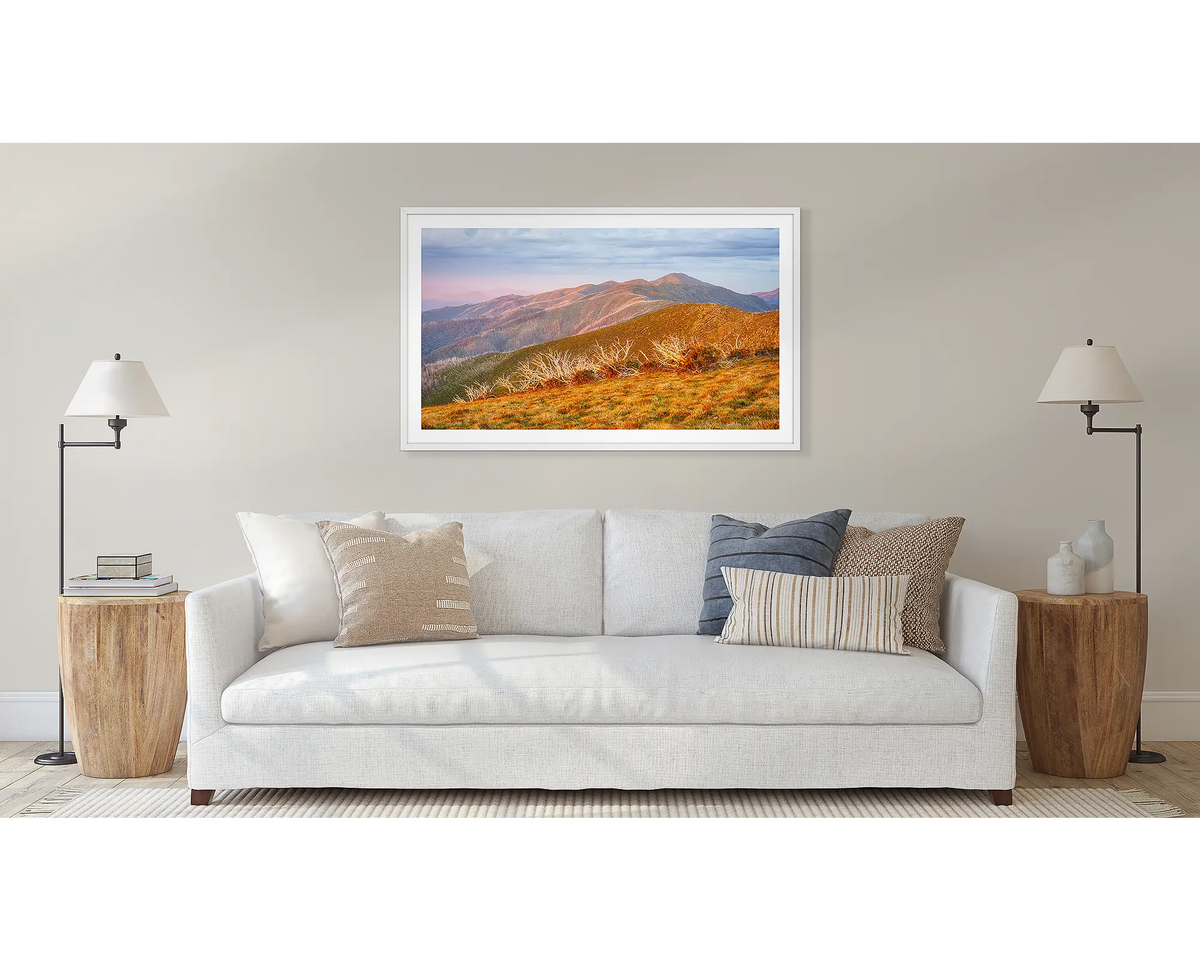 Summer Light framed landscape art print with a white frame, hung on a beige wall above a white sofa in a modern living room setting.