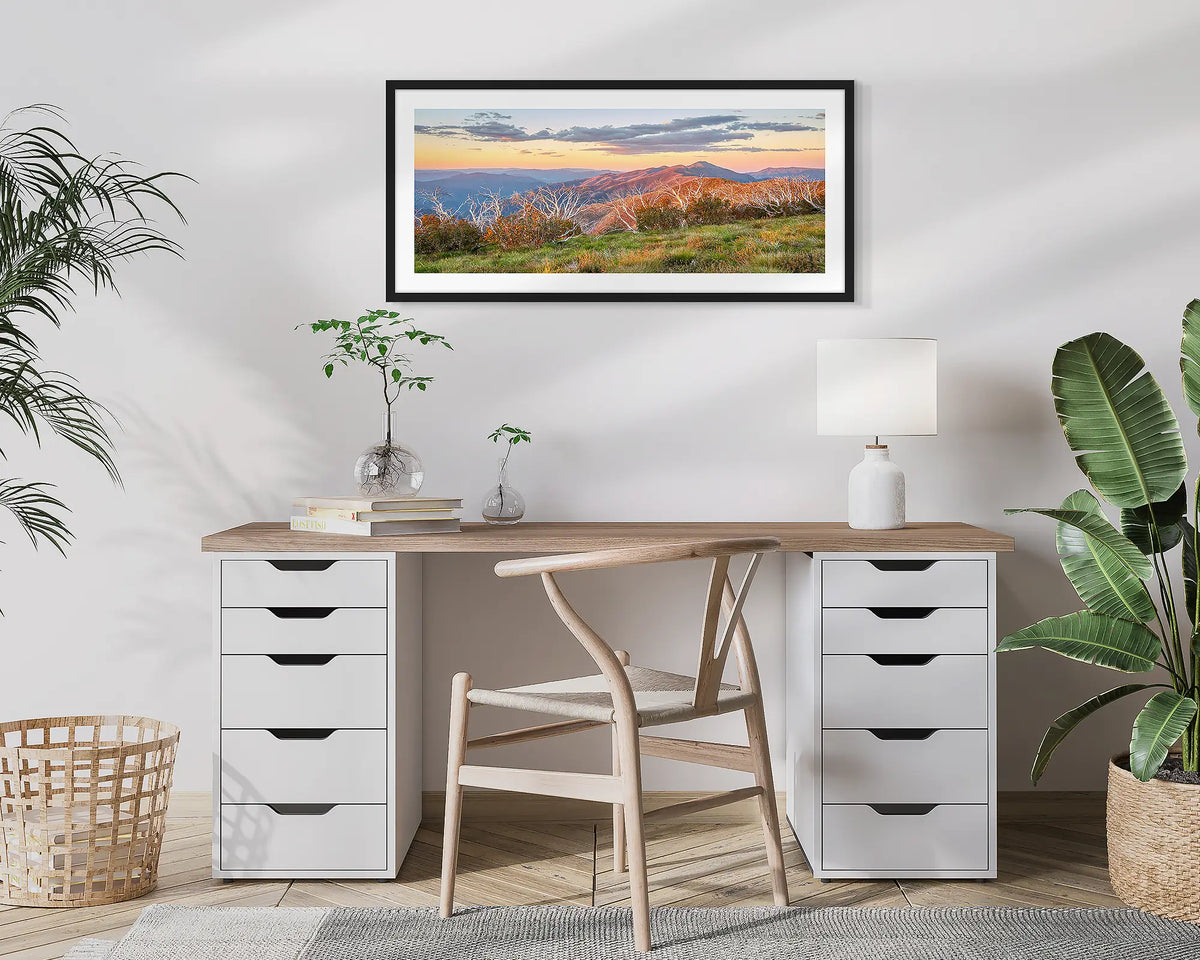 Summer Razorback. Framed wall art print of a sunset over the razorback and Mount Feathertop, framed in a black frame and hung above a desk. 