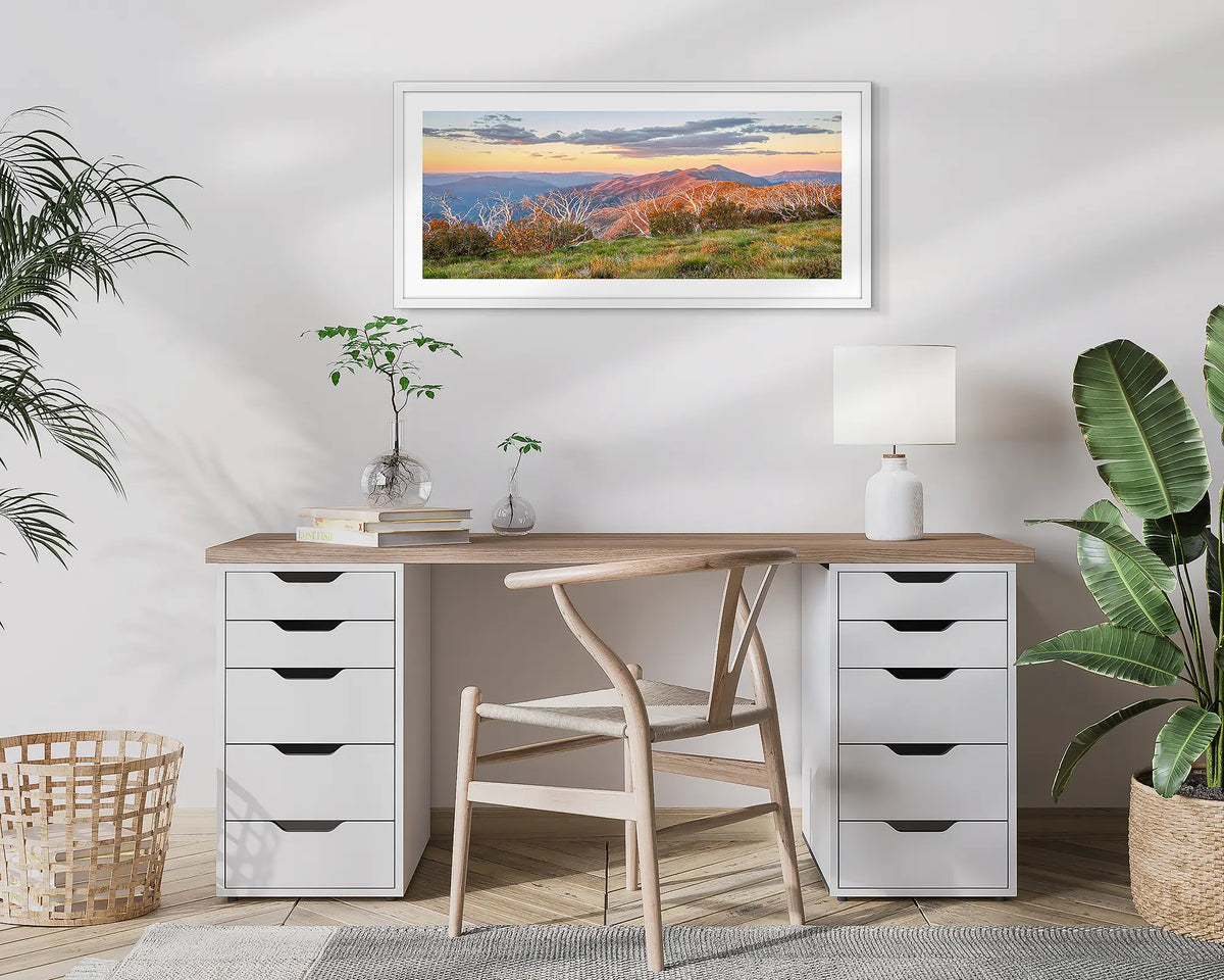 Summer Razorback. Framed wall art print of a sunset over the razorback and Mount Feathertop, framed in a white frame and hung above a desk. 