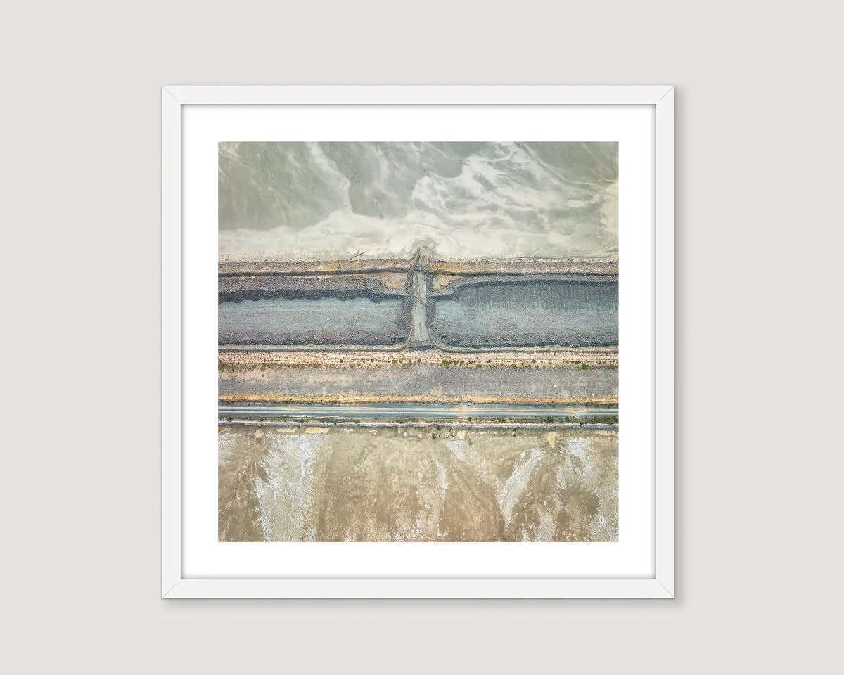 Framed abstract artwork of an old mining site with gradients of blue, white and beige.