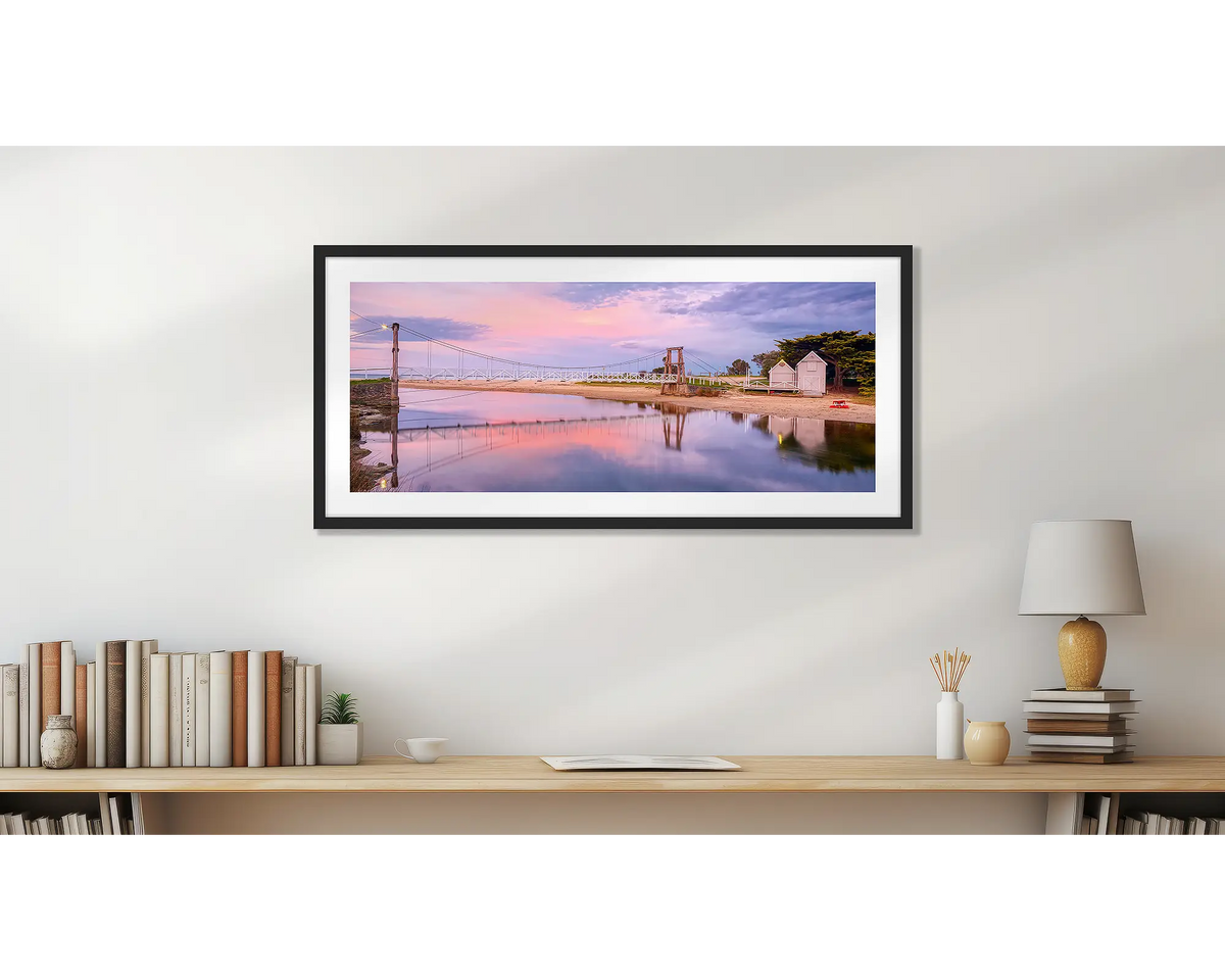 Swing Bridge. Lorne wall art print, with a black frame, hung above a small office shelf. 