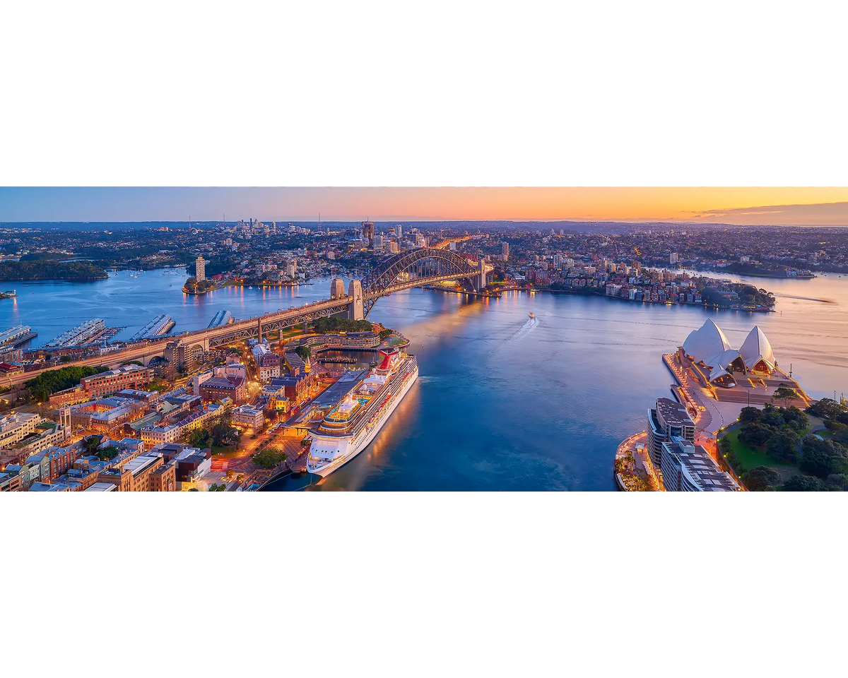 Sydney Awakes. Panoramic view of Sydney harbour at sunrise.