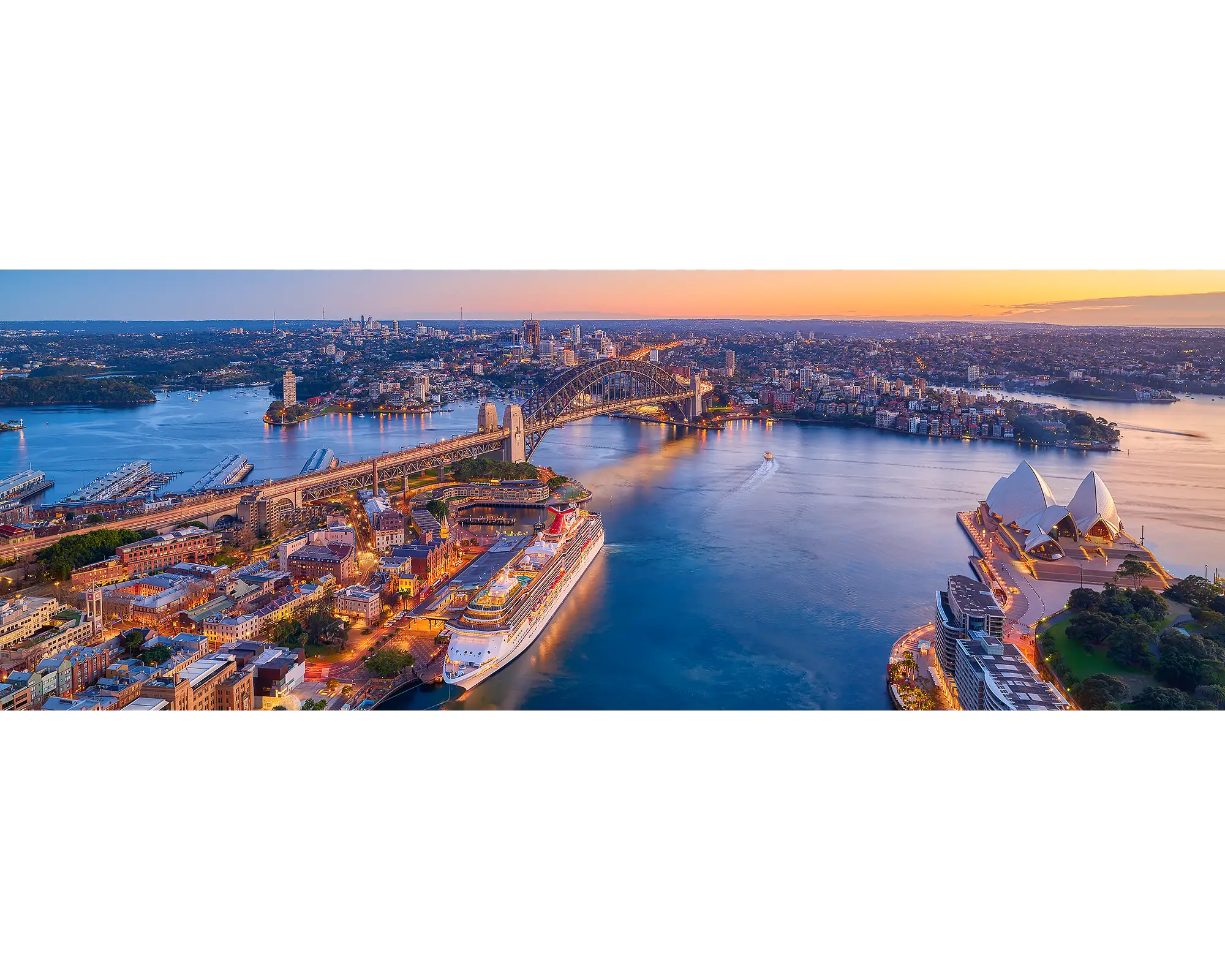 Sydney Awakes. Panoramic view of Sydney harbour at sunrise.