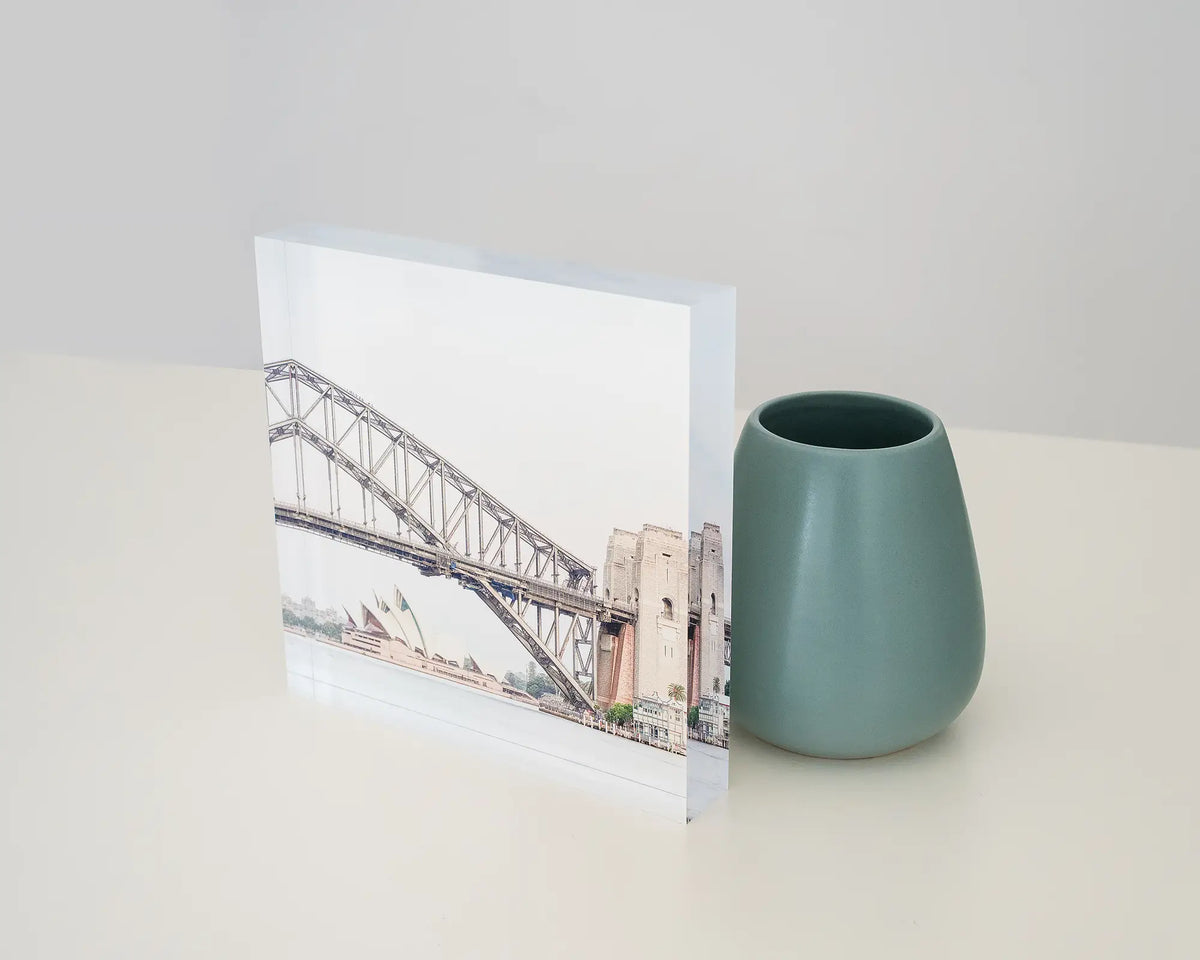 Sydney Icons. Acrylic block of the Opera House and Harbour Bridge, styled on a desk with a small vase.