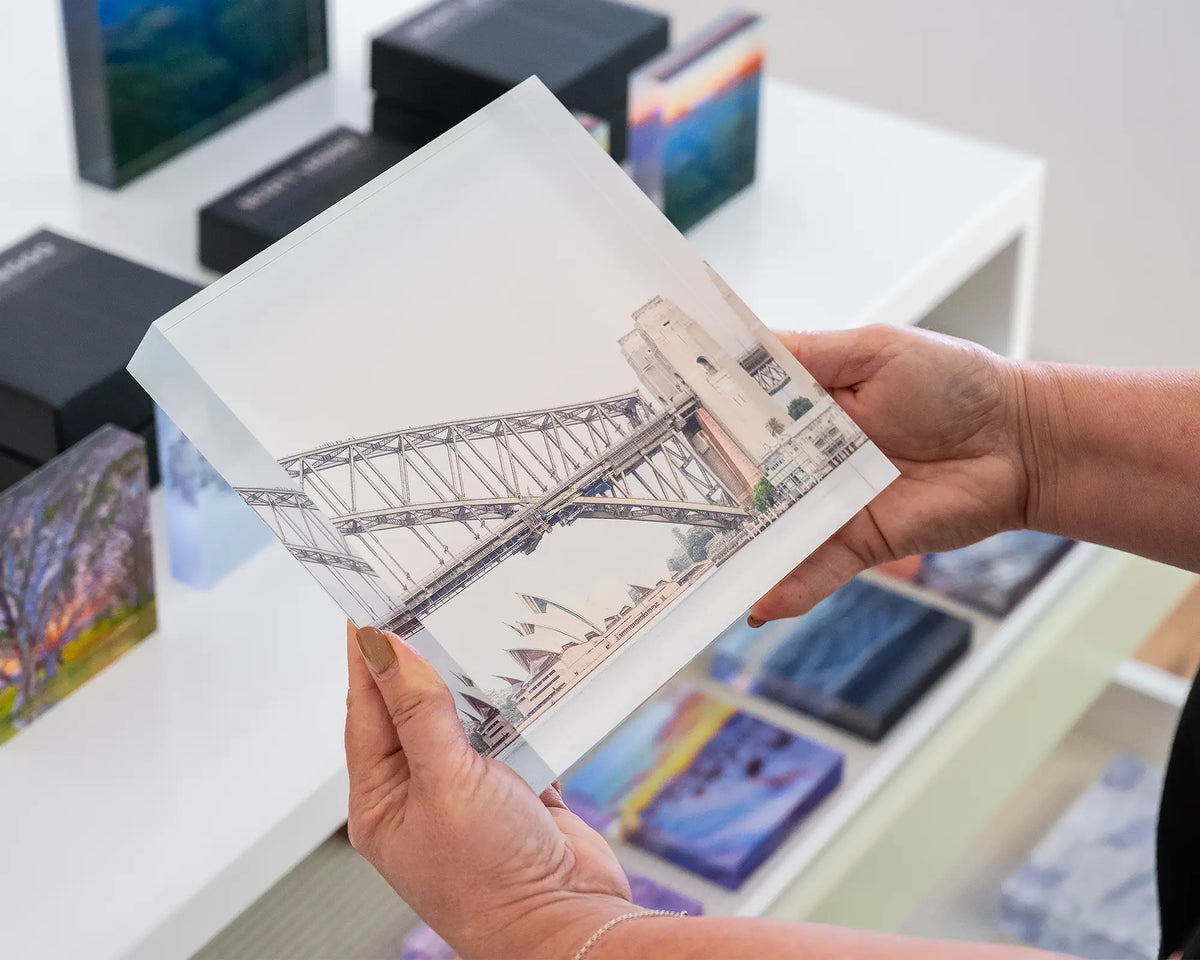 Sydney Icons. Acrylic block of the Harbour Bridge and Opera House being held in hands.
