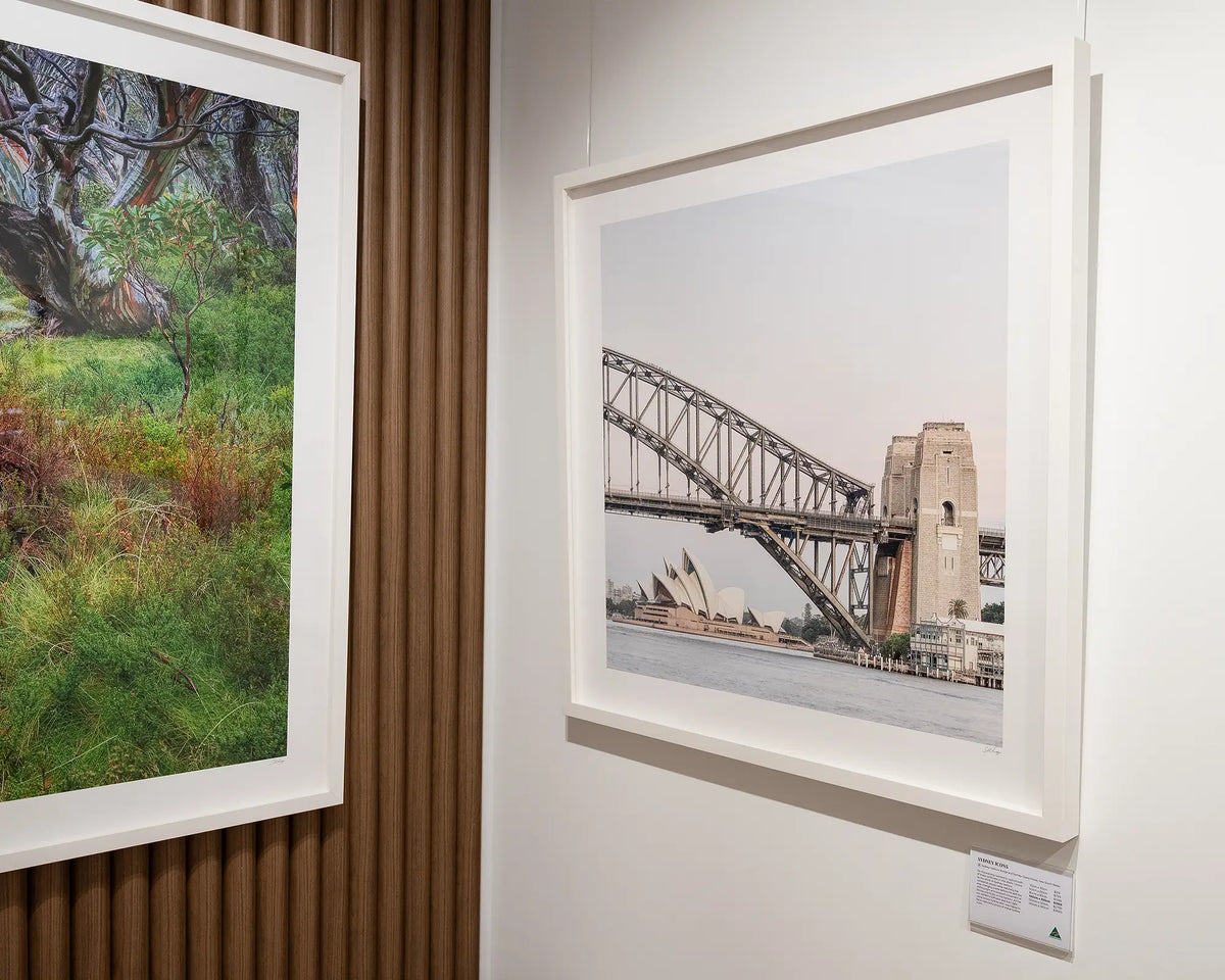 Sydney Icons. Harbour Bridge and Opera House with white frame on gallery wall.