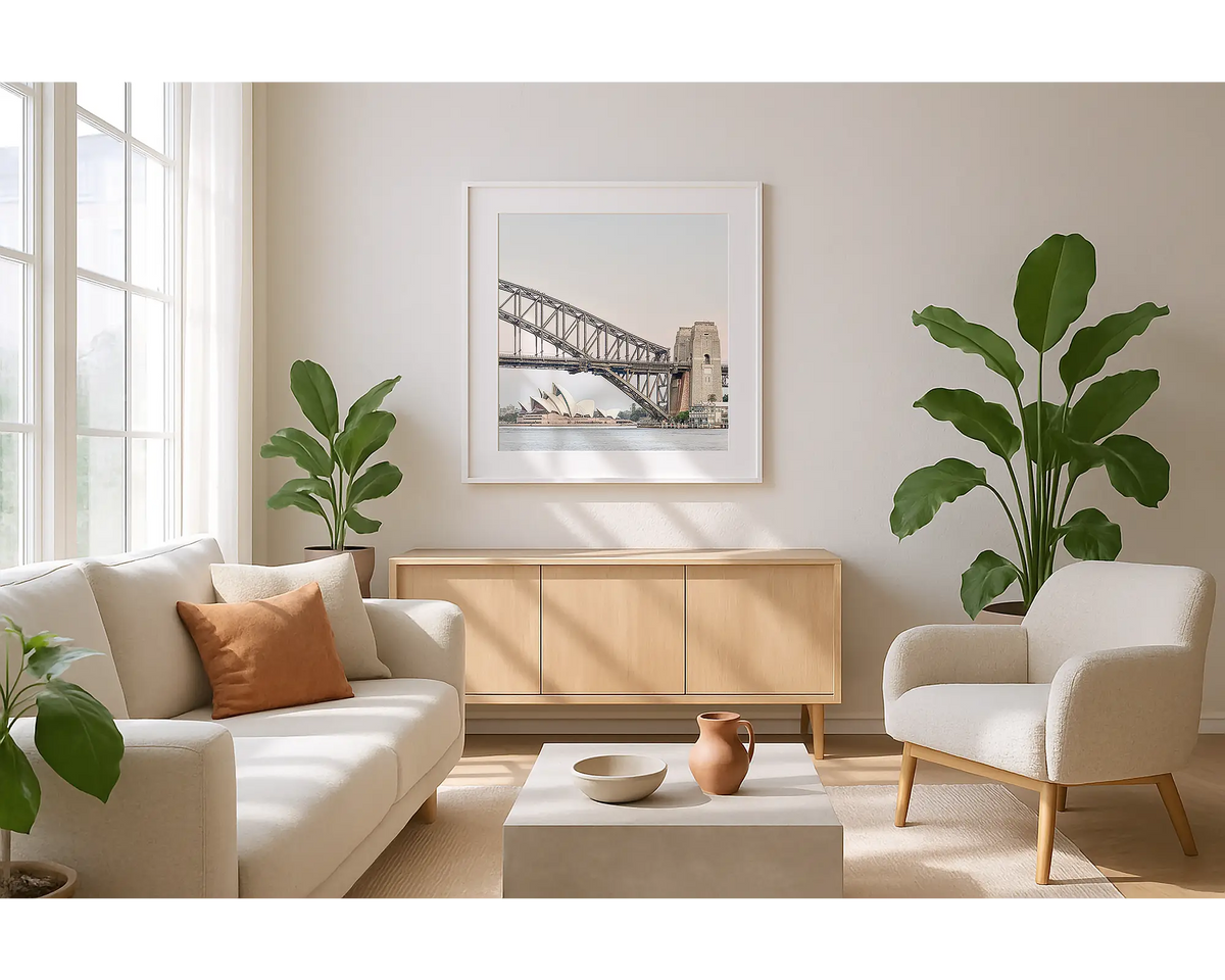 Sydney Icons. Wall art print of Sydney Opera House and Sydney Harbour Bridge, with a white frame hung in a sunlit lounge room. 