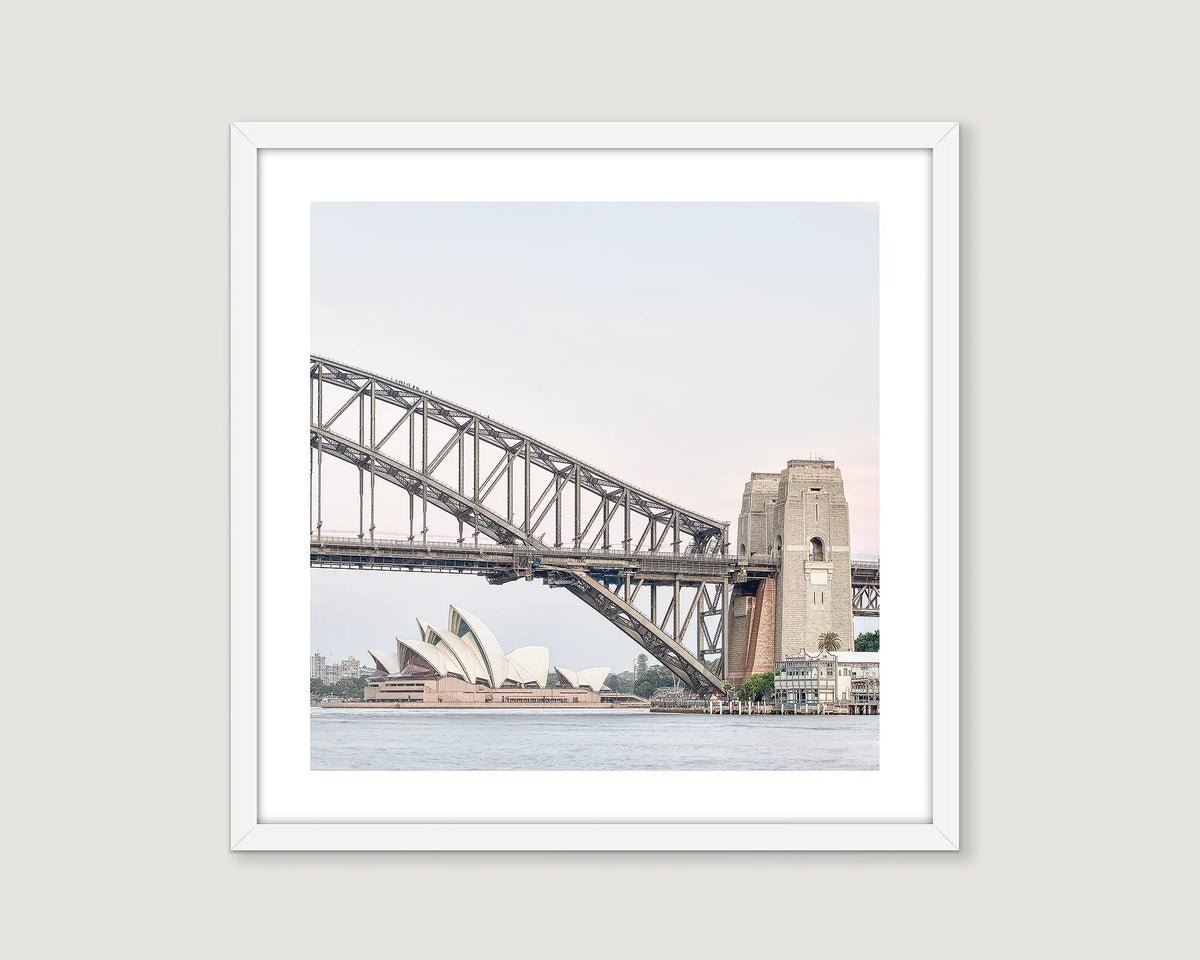 Framed photograph of the Sydney Harbour Bridge and Opera House on a light grey background.