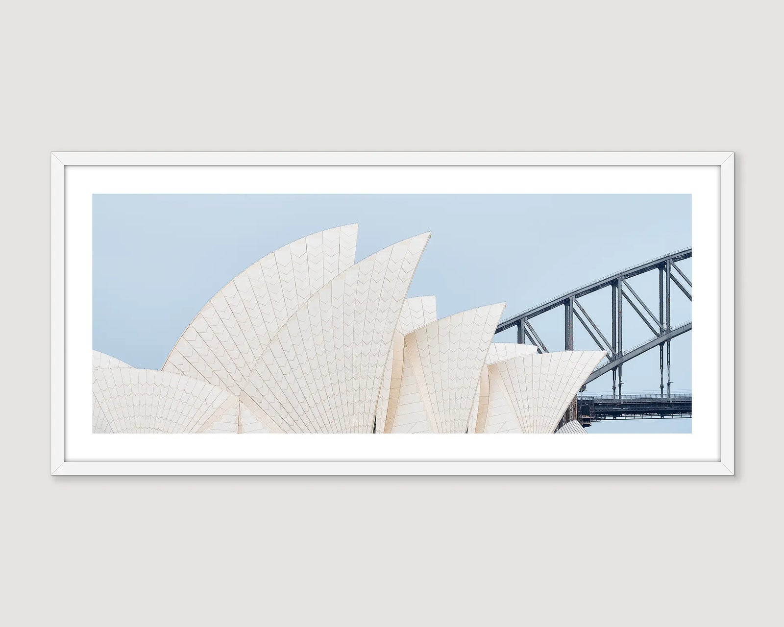 Framed photograph of the Sydney Opera House and Bridge against a blue sky.