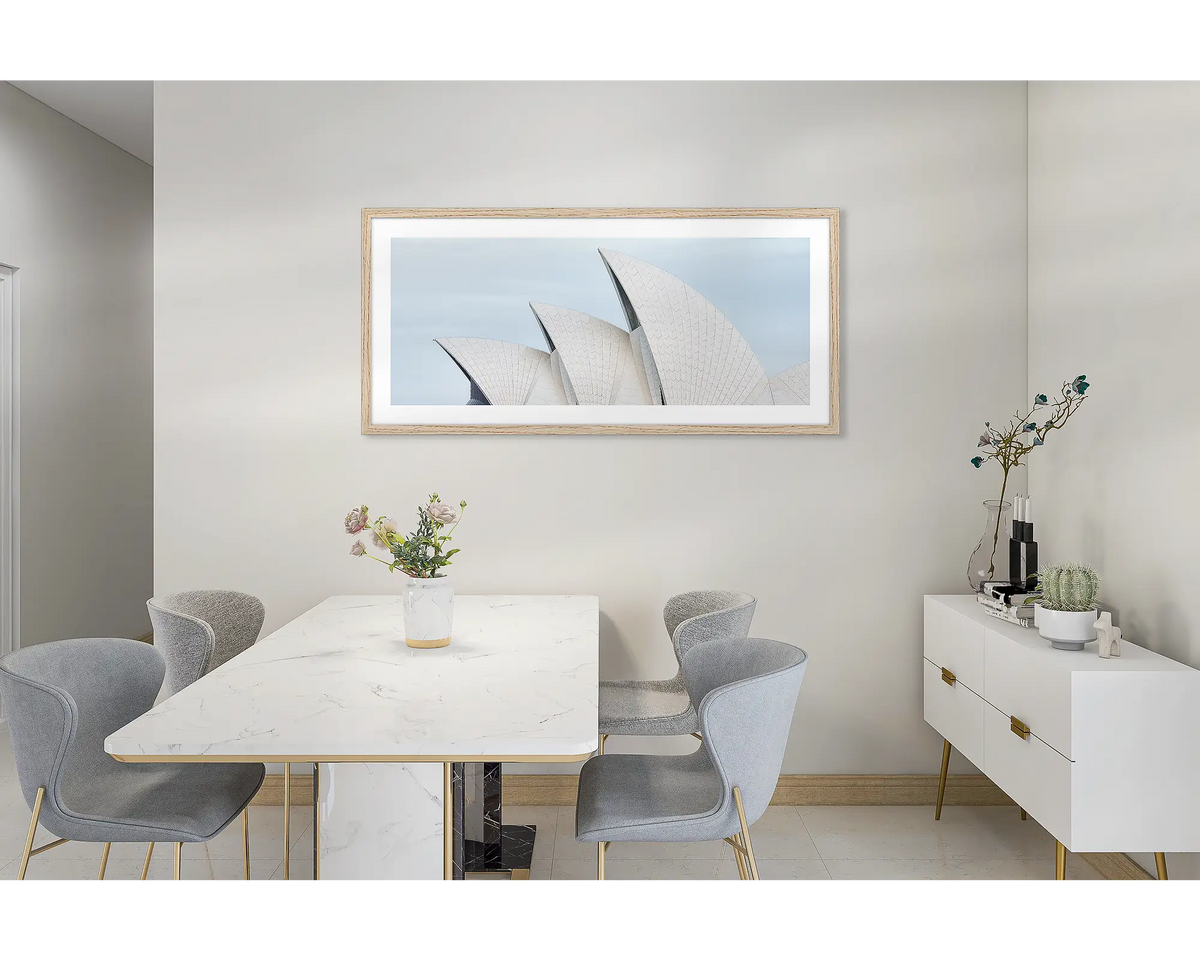 Sydney Outlines. Wall art print featuring Sydney Opera House and Harbour Bridge with a timber frame, hung in a dining room. 