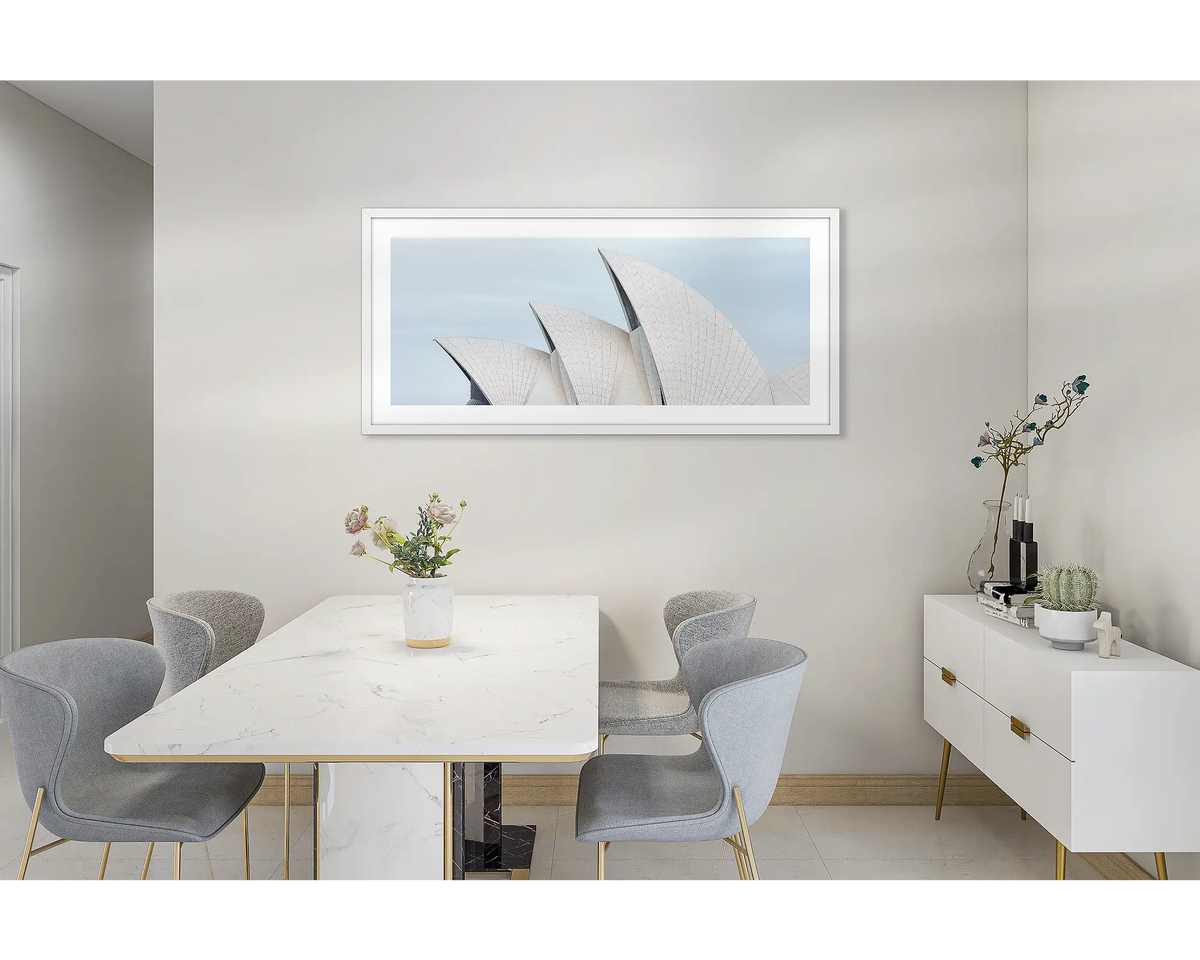 Sydney Outlines. Wall art print featuring Sydney Opera House and Harbour Bridge with a white frame, hung in a dining room. 