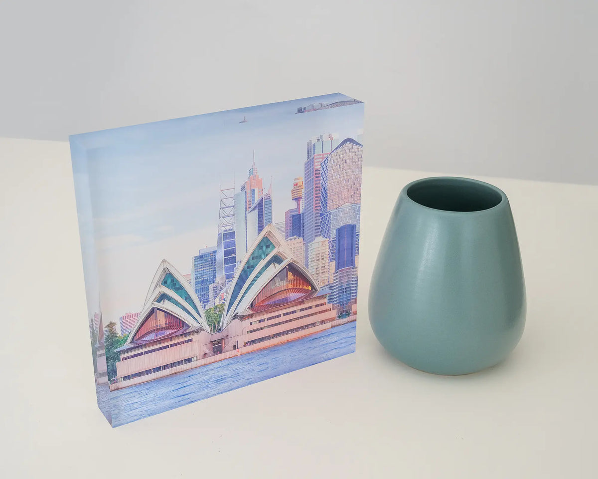 Sydney Views. Acrylic block of the Opera House at sunset, styled on a desk with a small vase.