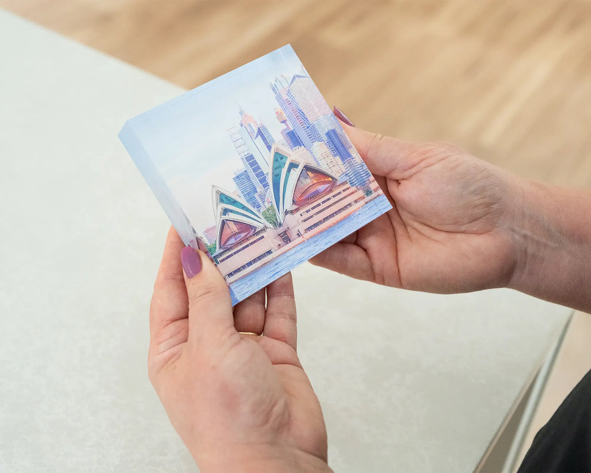 Sydney Views. Acrylic block of sunset over Sydney Opera House, held in hands.