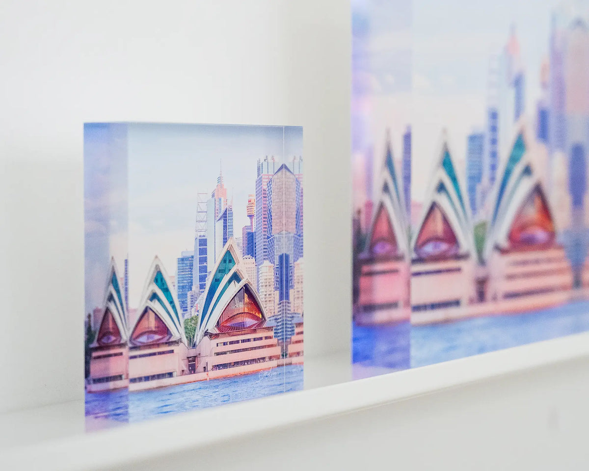 Sydney Views. Acrylic block sunset over Sydney Opera House, on display in gallery with larger SYDNEY VIEWS block.