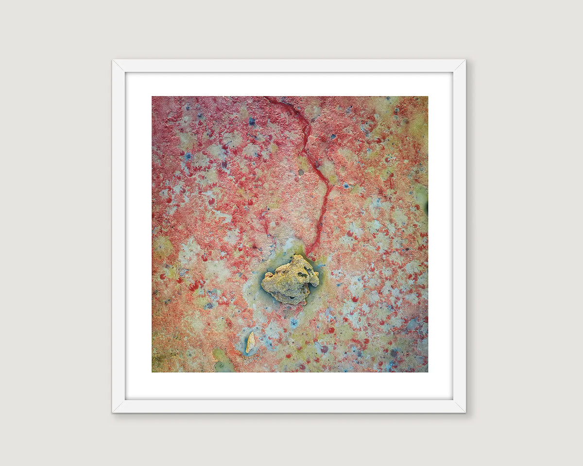 Framed abstract artwork with a central yellow/green circle on a multicoloured background.