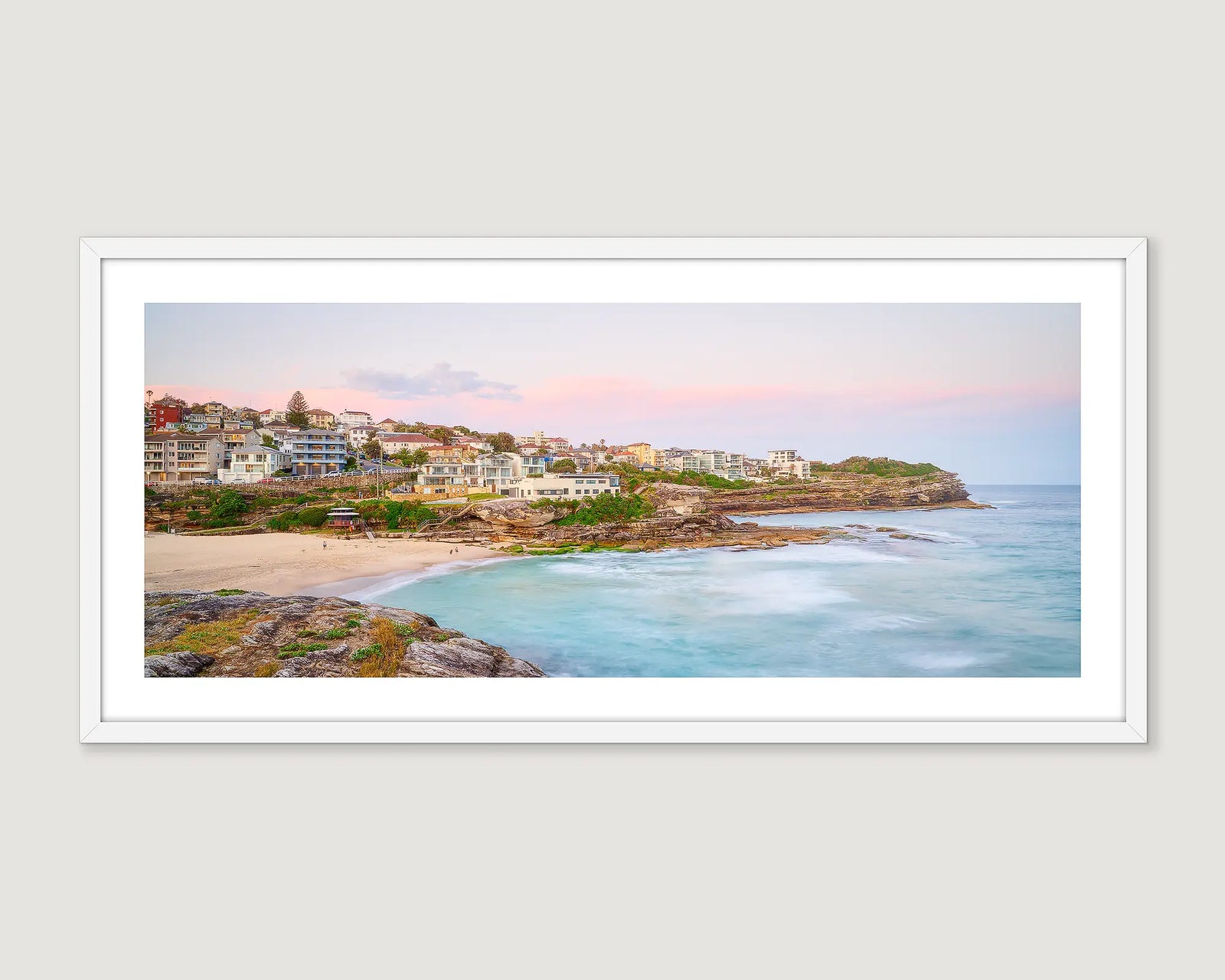 Framed artwork of a coastal scene with houses and a beach at Tamarama.