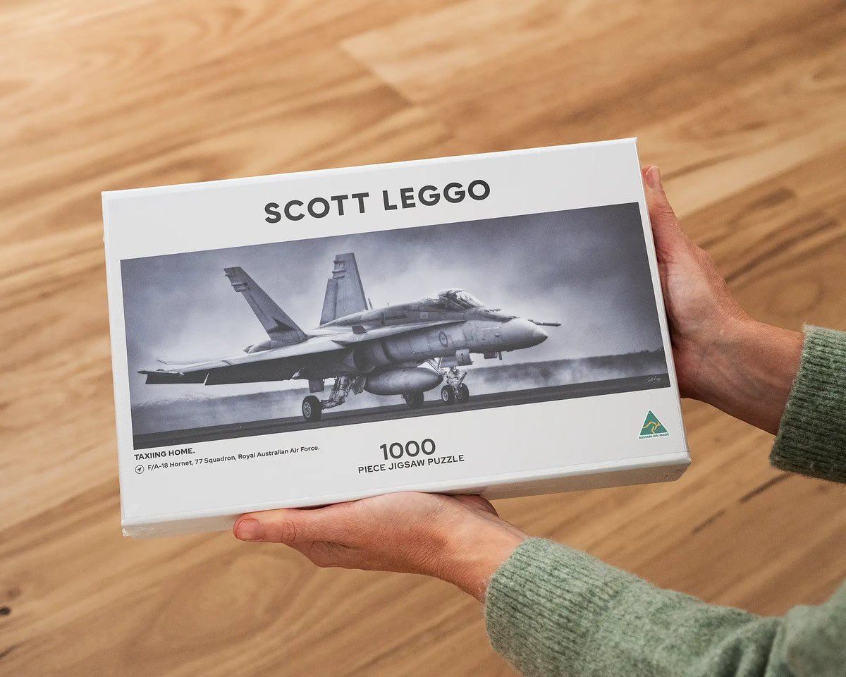 Taxiing Home 1000 piece aviation jigsaw puzzle box being held.