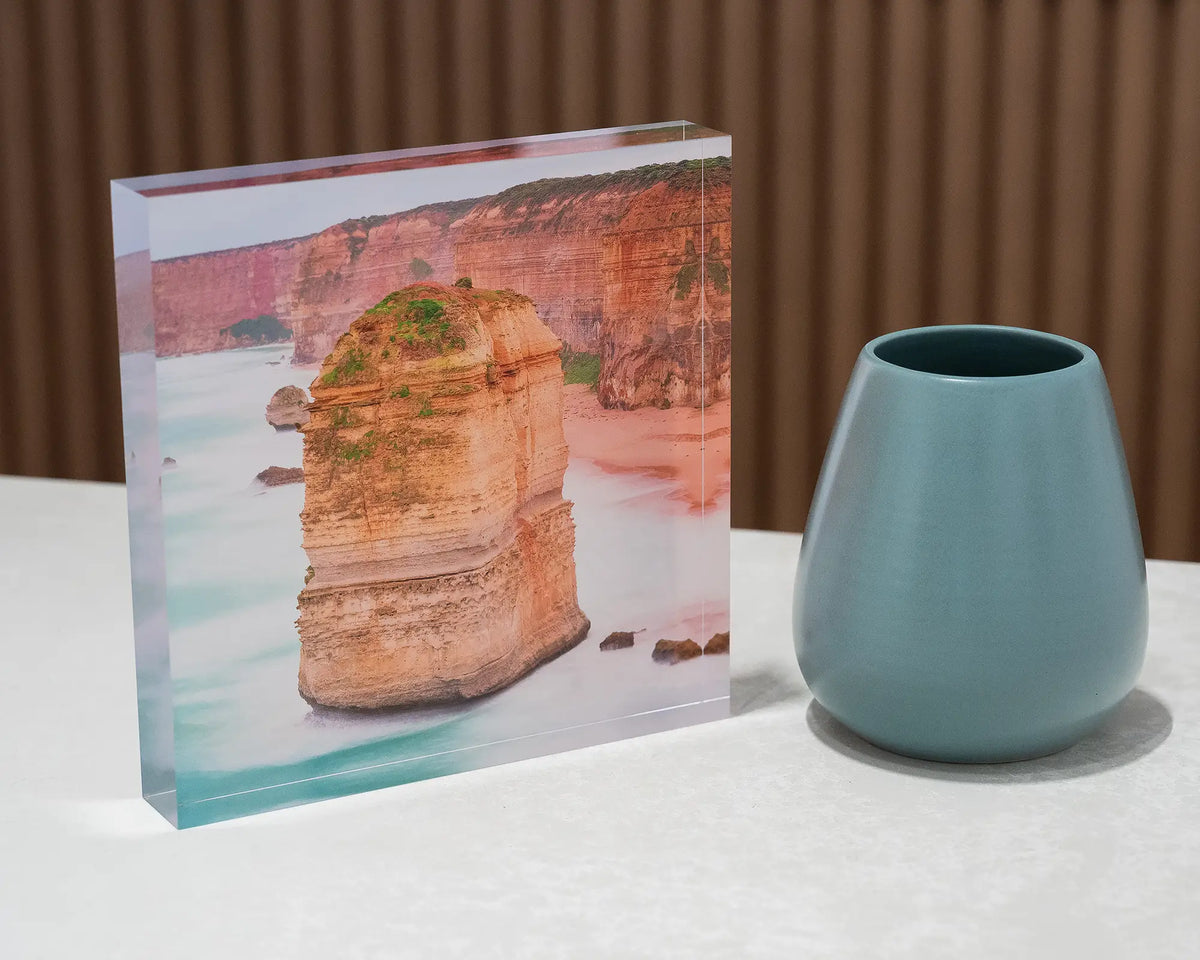 The Apostle. Acrylic block Twelve Apostles, Great Ocean Road, Victoria, on desk styled with a small vase.