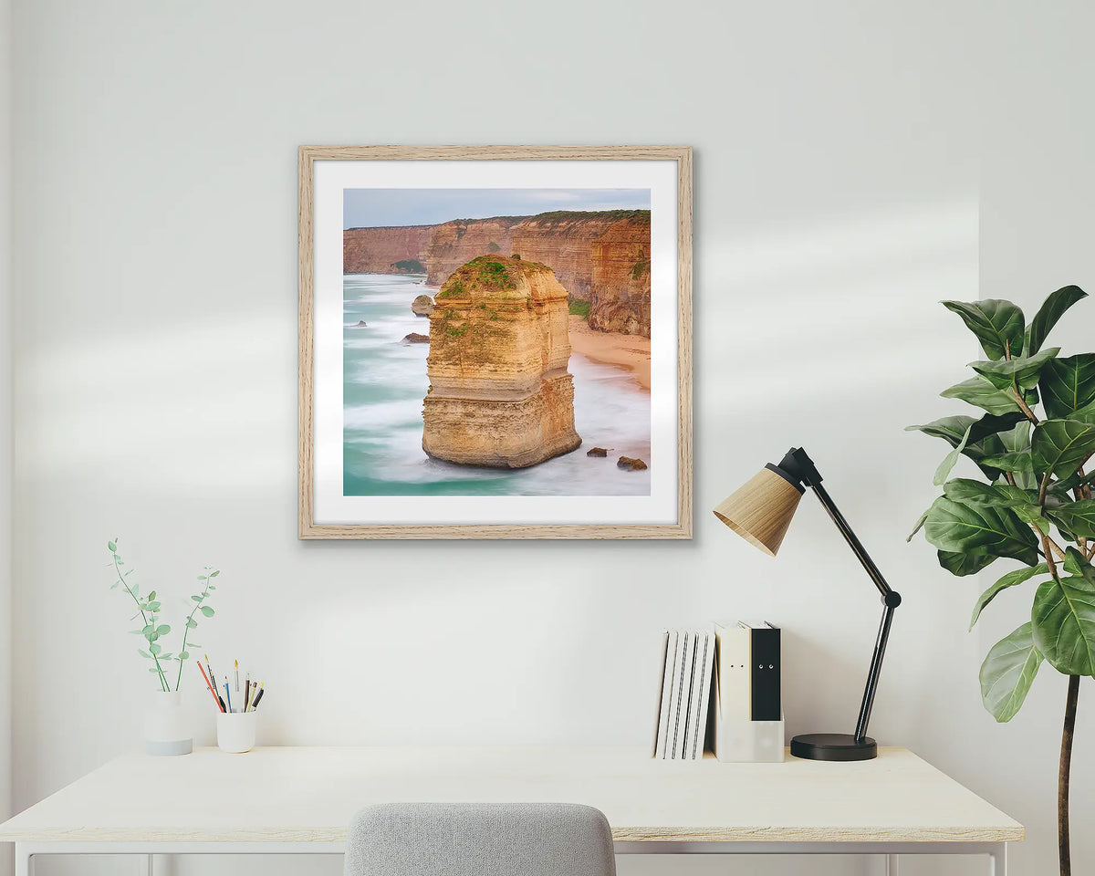 The Apostle. Great Ocean Road wall art print with a timber frame hung above a small home office desk. 