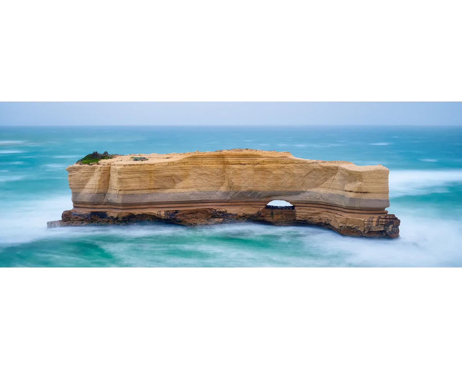 The Bakers Oven rock formation, Great Ocean Road, in the middle of the Southern Ocean with a clear sky,