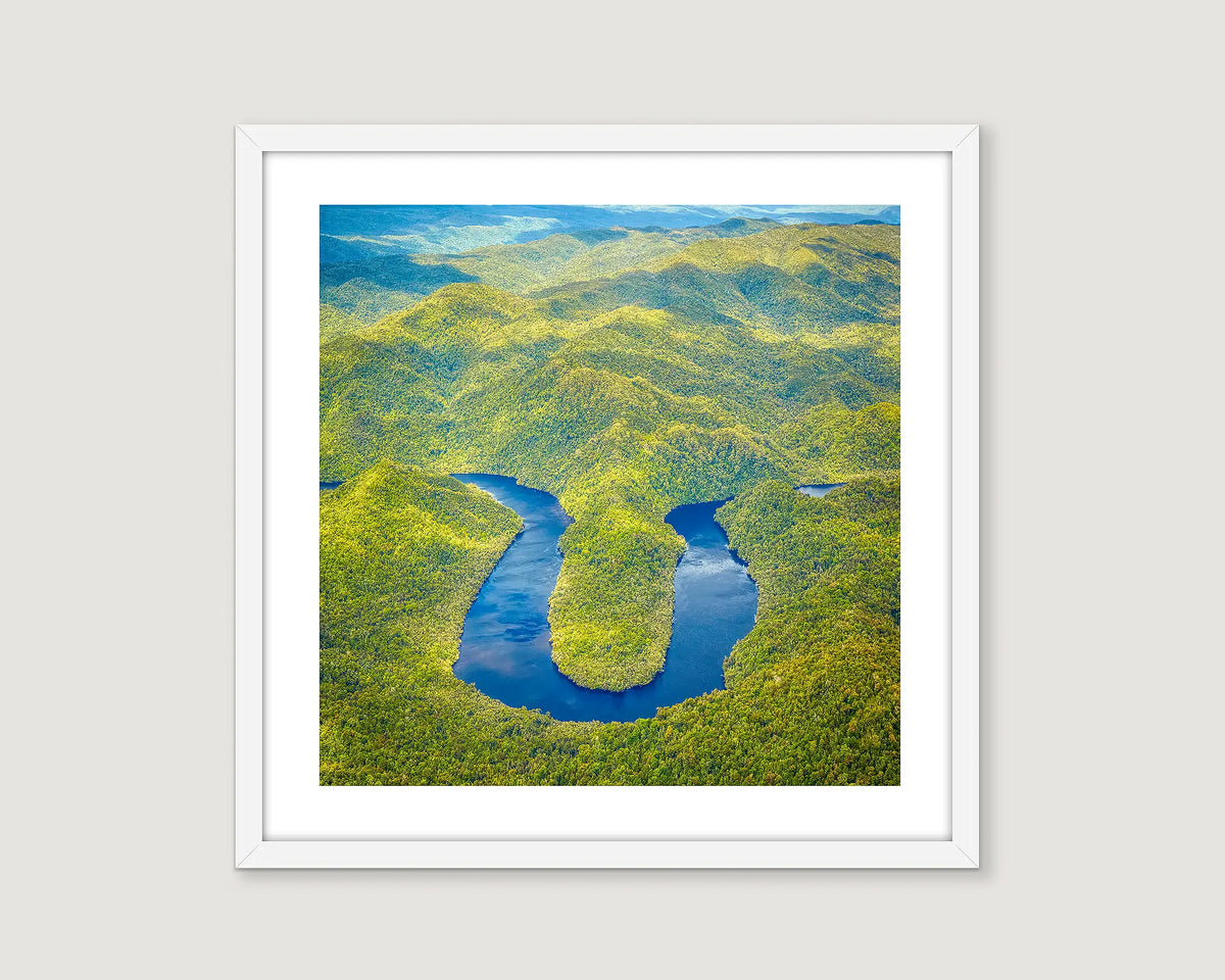Framed aerial view of a river meandering through a green landscape on the Gordon River.