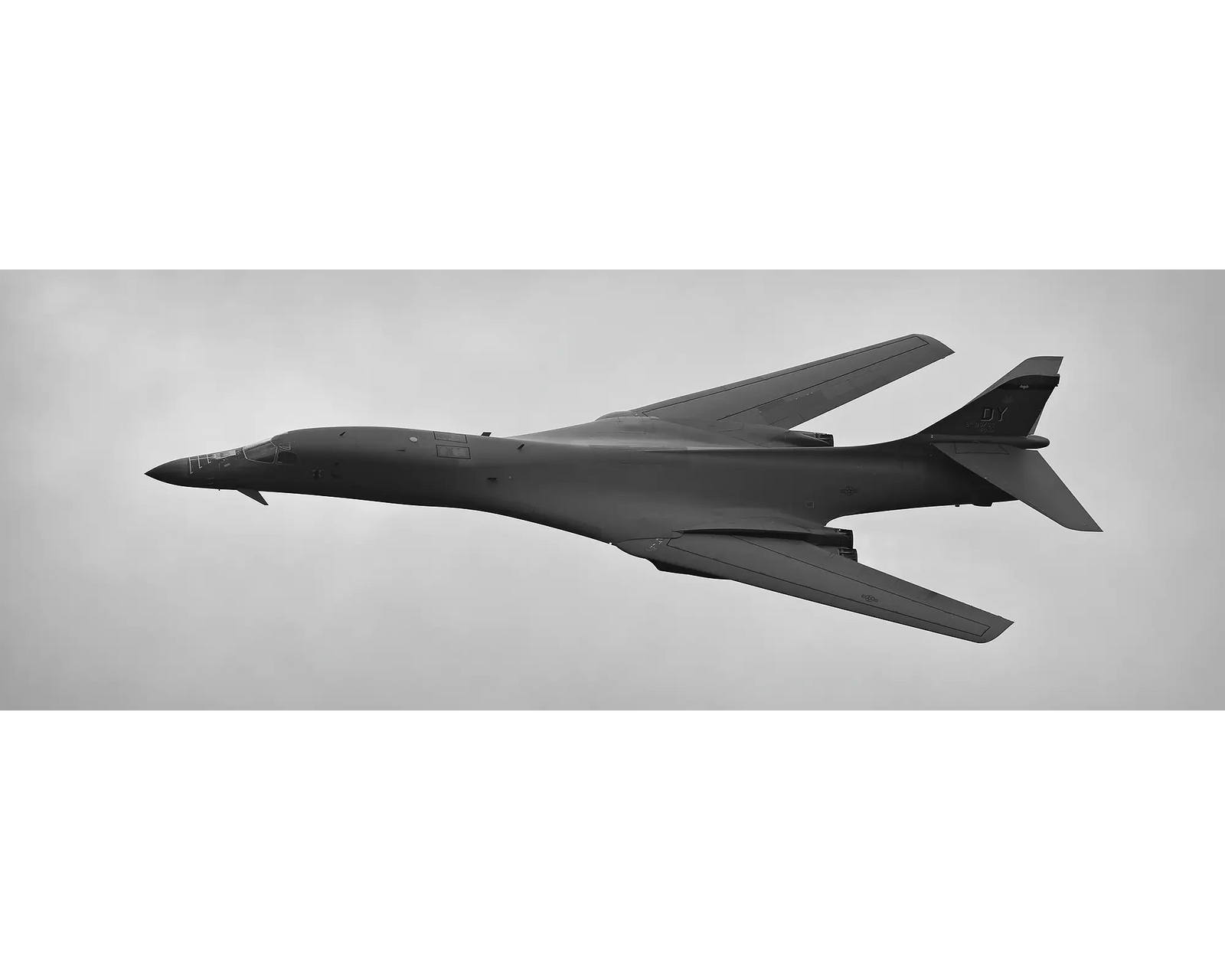 United States Air Force B-1B Lancer flying through clouds. 