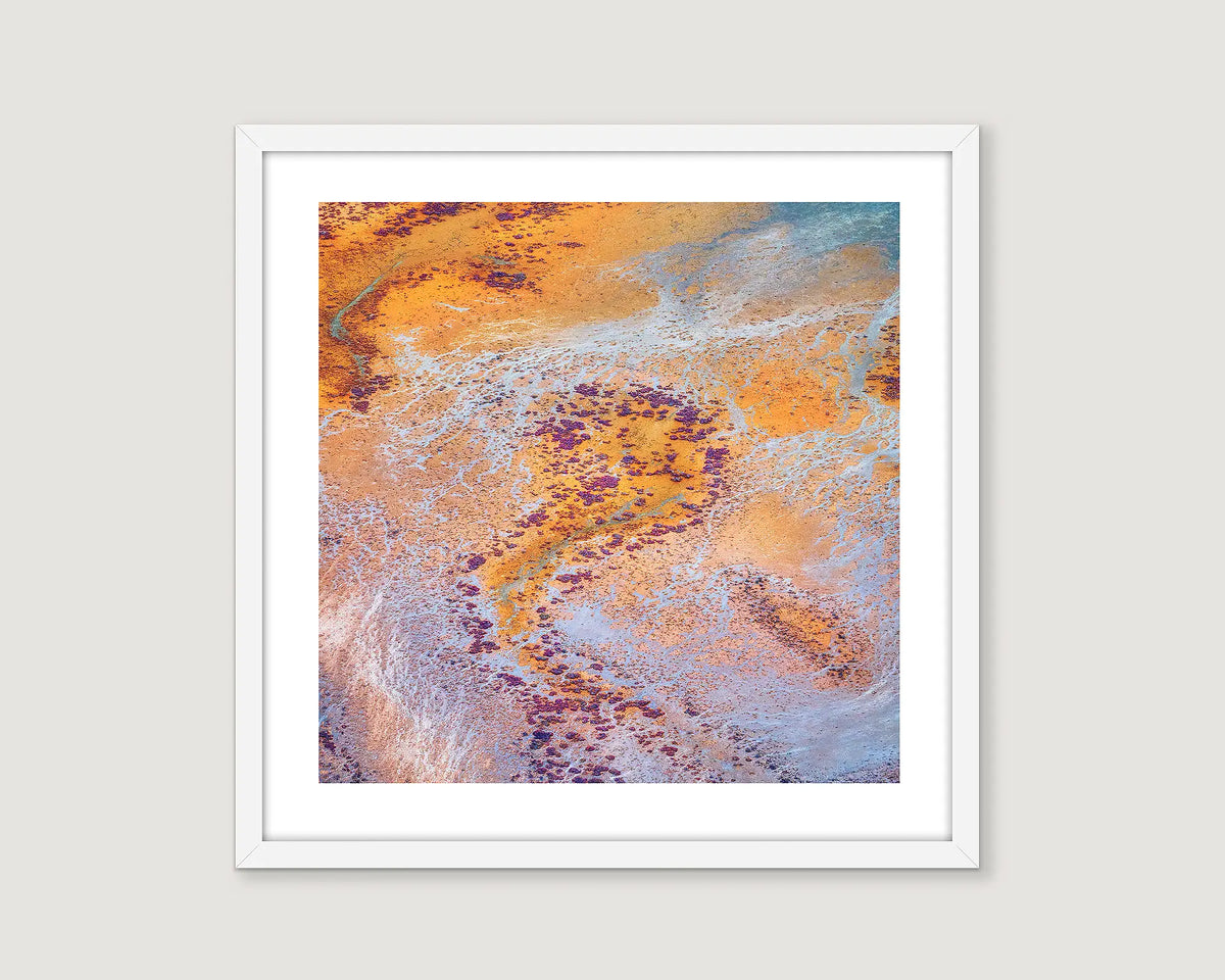 Framed abstract art print with orange, purple, and blue colors on a white background.