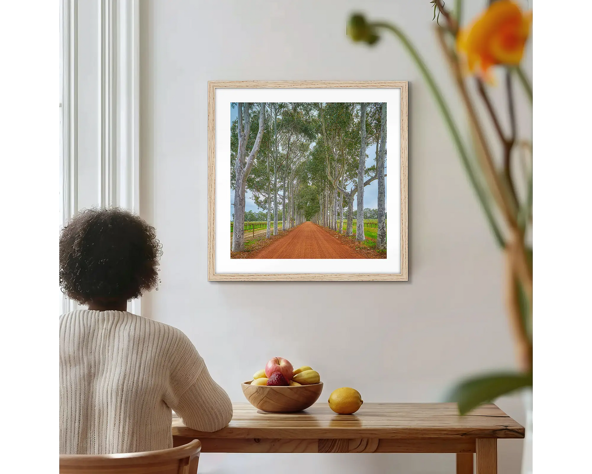 The Entrance. Margaret River Winery,  photographic wall art print with a timber frame, hung on a kitchen wall with a woman admiring. 
