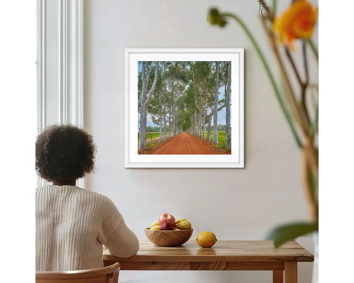 The Entrance. Margaret River Winery,  photographic wall art print with a white frame, hung on a kitchen wall with a woman admiring. 