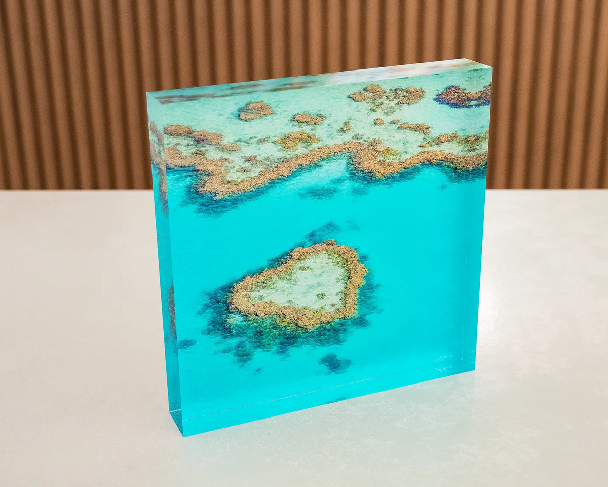 The Heart. Acrylic block Heart Reef, The Great Barrier Reef, Queensland, sitting on a desk.