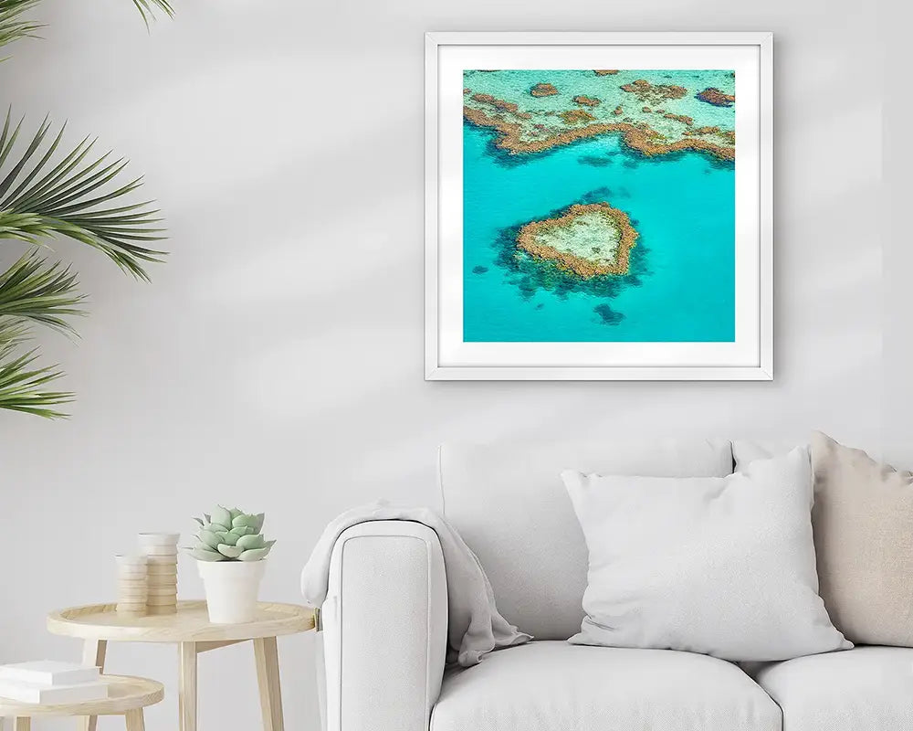 The Heart, framed wall art print hung above couch in light filled room.